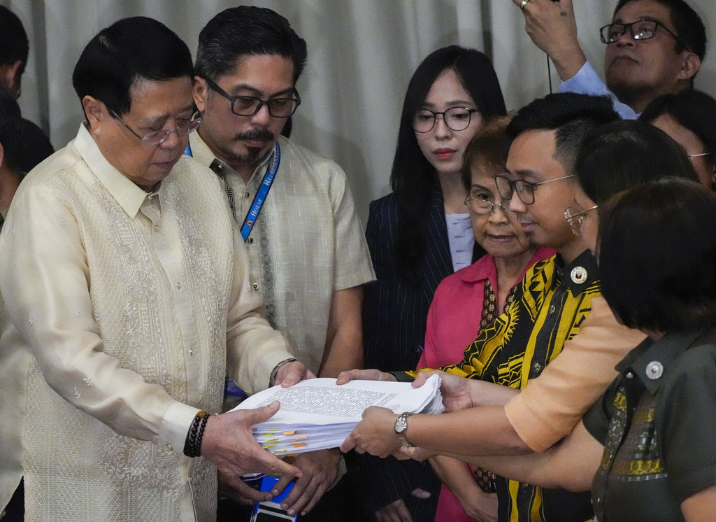 House Secretary General, Reginald Velasco, left, receives a second impeachment complaint filed against Philippine Vice President Sara Duterte at the House of Representatives in Quezon City, the Philippines, on December 4, 2024