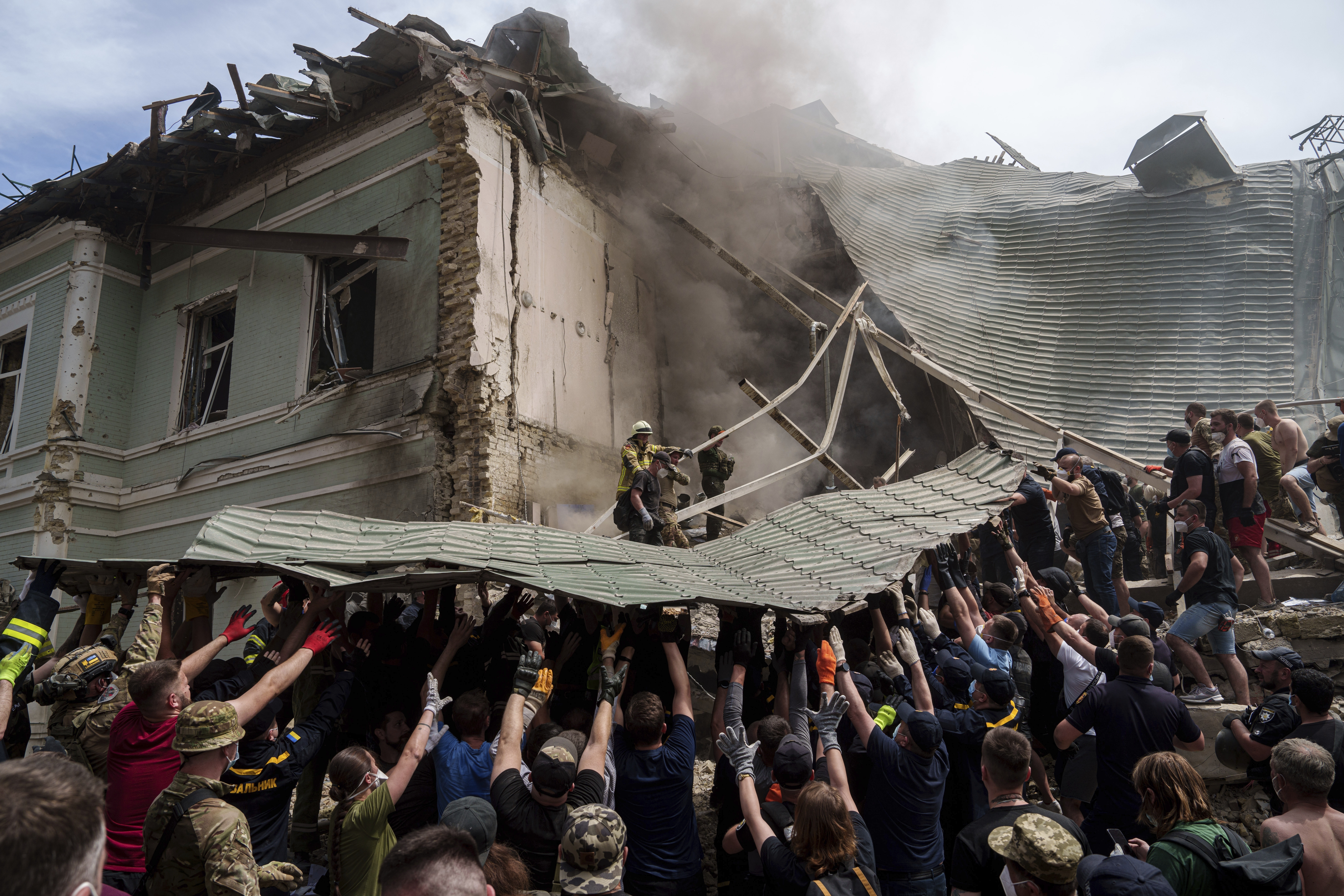Emergency services work at the site of Okhmatdyt children's hospital hit by Russian missiles, in Kyiv, Ukraine, Monday, July 8
