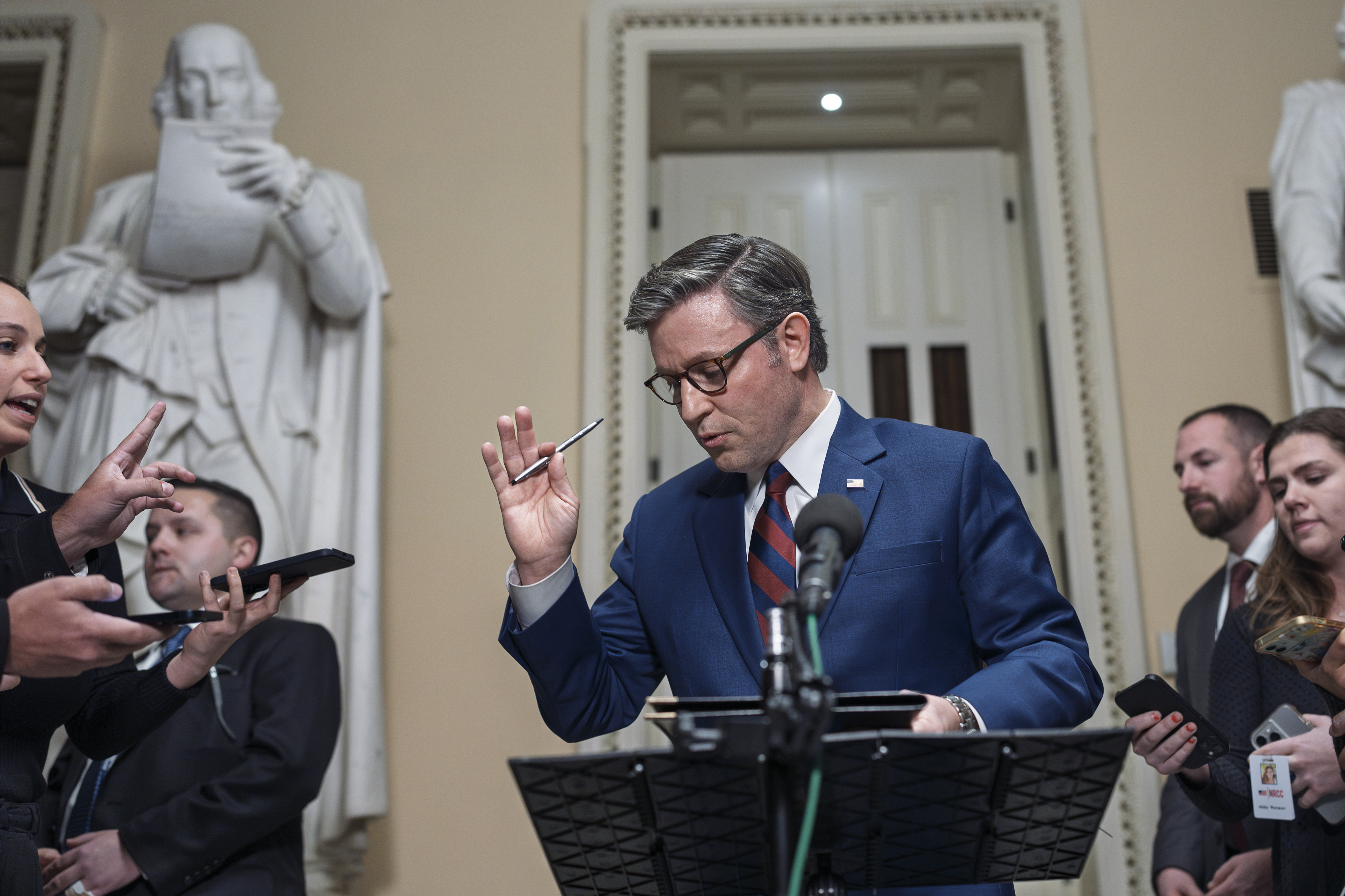 Speaker Mike Johnson speaks behind a podium in Congress.