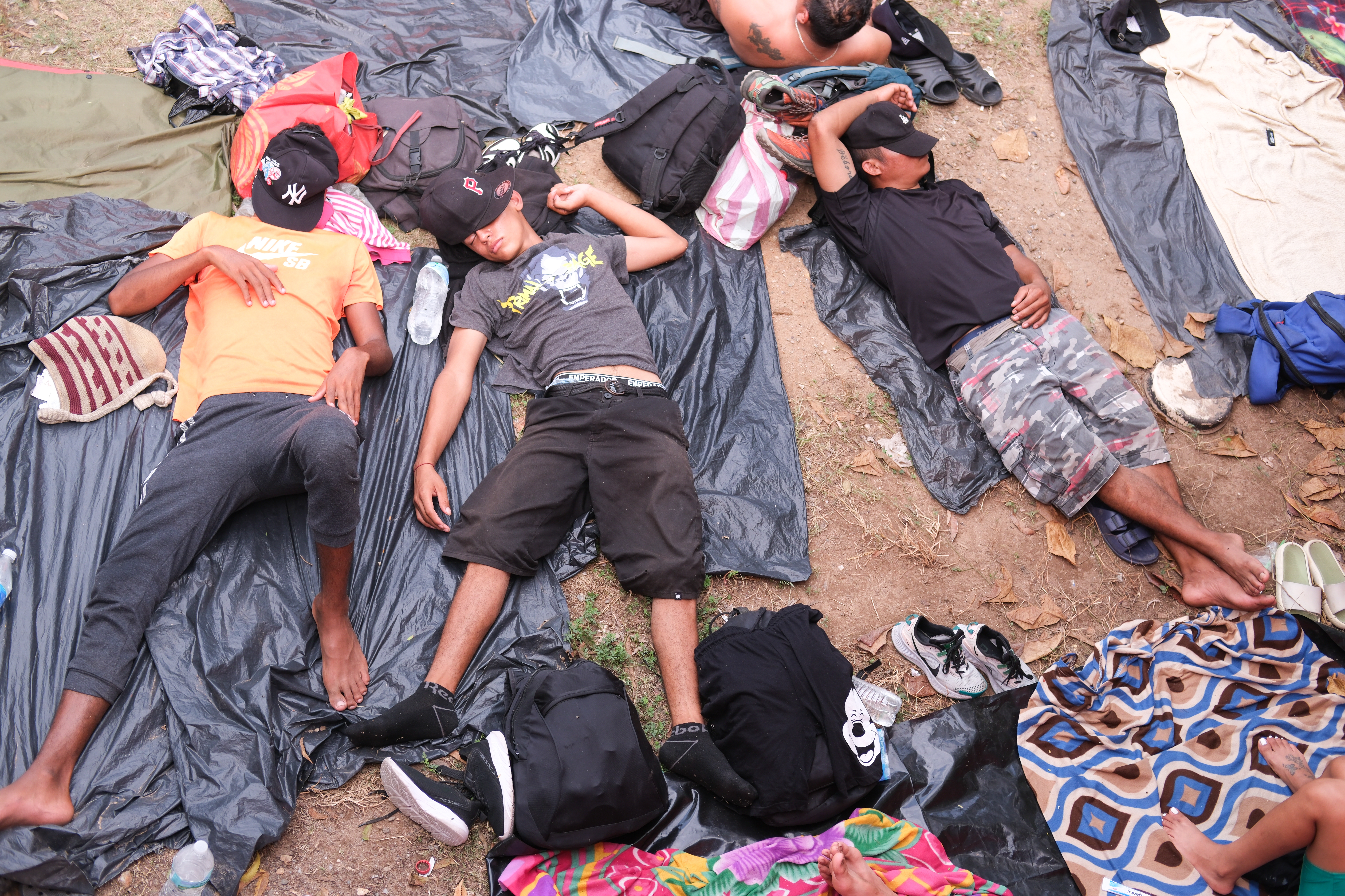 Migrants and asylum seekers lie on sleeping bags in Santiago Niltepec, Mexico