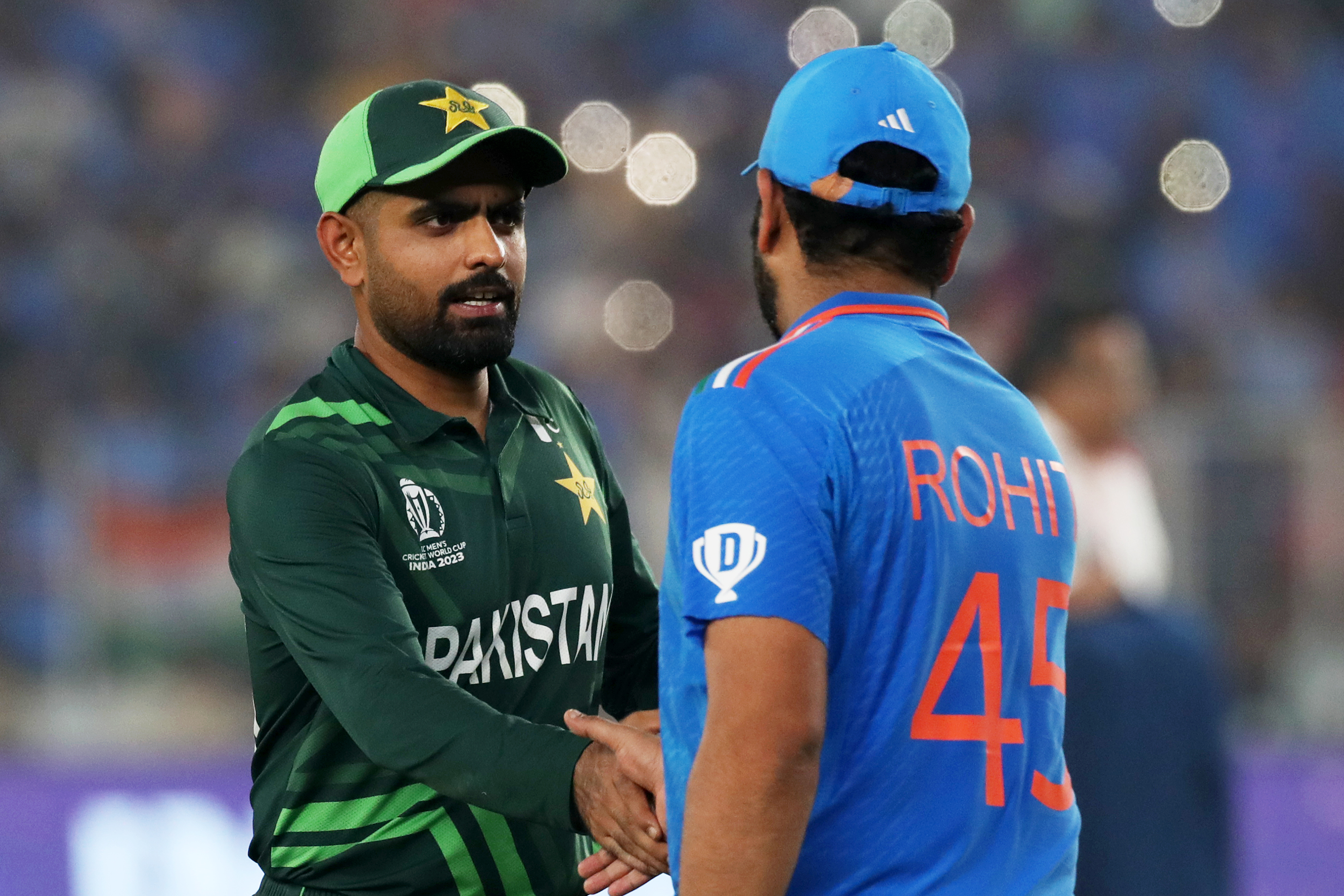 Babar Azam and Rohit Sharma shake hands.