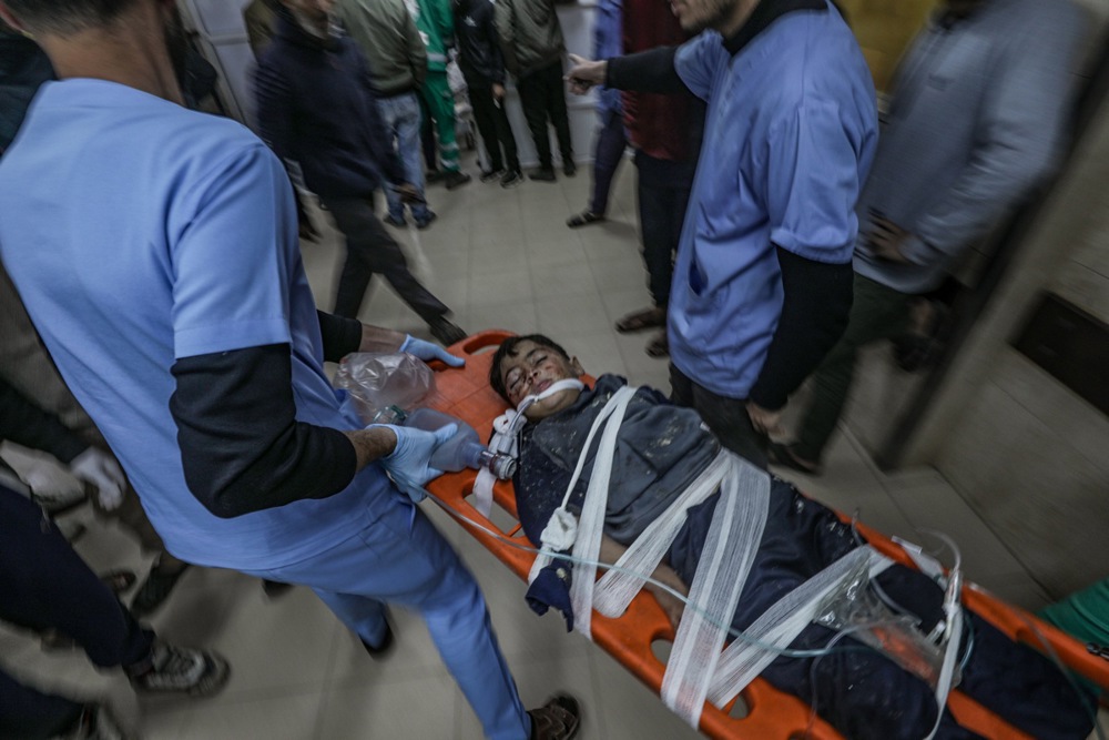 epa11806193 A wounded Palestinian boy on a stretcher arrives at Al Aqsa hospital following an Israeli air strike on Al Bureije refugee camp, in Deir Al Balah town, central Gaza Strip, 04 January 2025. According to reports from the Ministry of Health in Gaza, at least three Palestinians were killed and more than 27 others wounded following an Israeli air strike in Al Bureije refugee camp. More than 45,500 Palestinians and over 1,400 Israelis have been killed, according to the Palestinian Health Ministry and the Israeli Army, since Hamas militants launched an attack against Israel from the Gaza Strip on 07 October 2023 and the Israeli operations in Gaza and the West Bank that followed it. EPA-EFE/MOHAMMED SABER