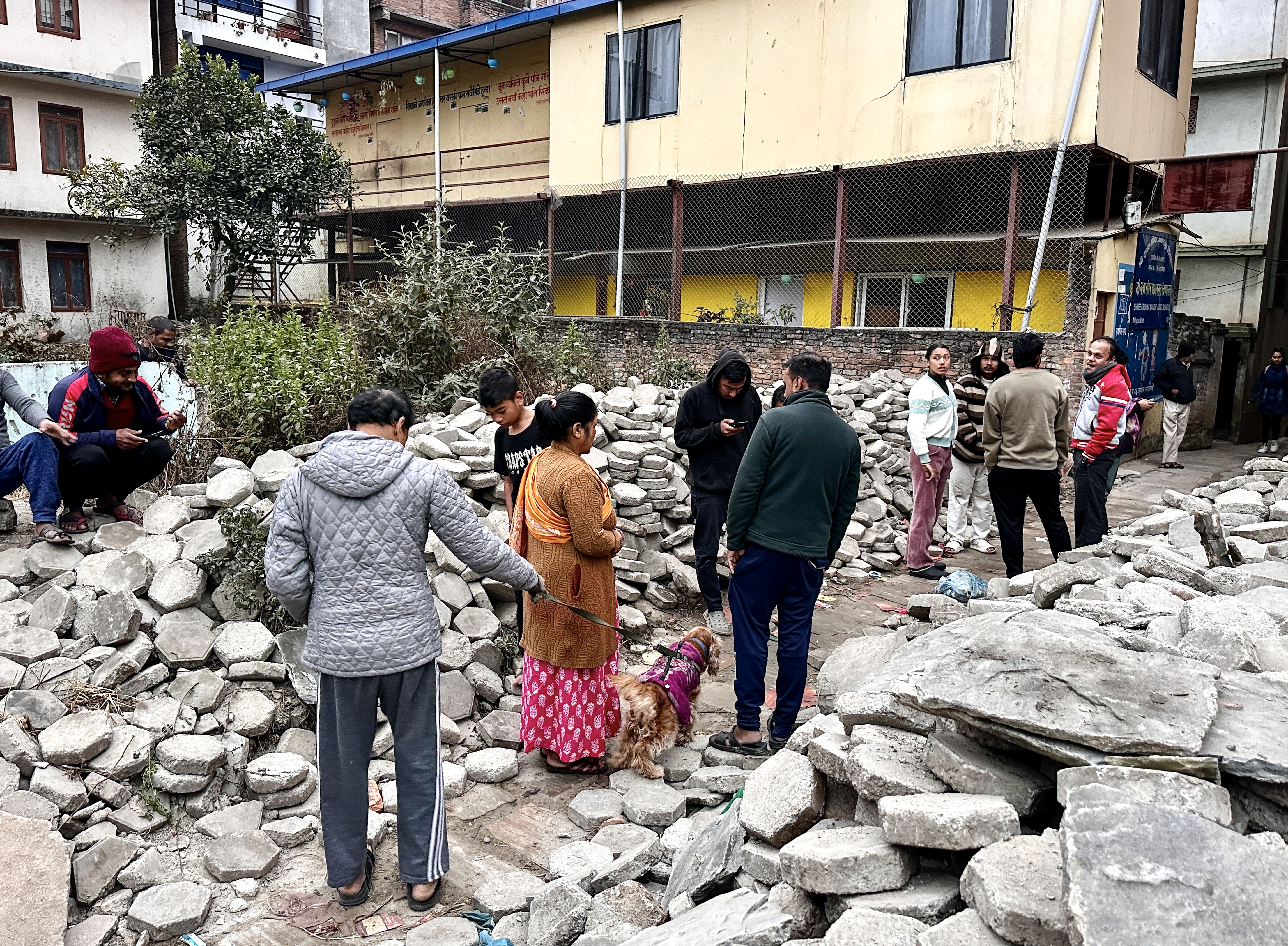 Nepalese people gather after getting out of their homes following an early morning earthquake in Kathmandu, Nepal, 07 January 2025