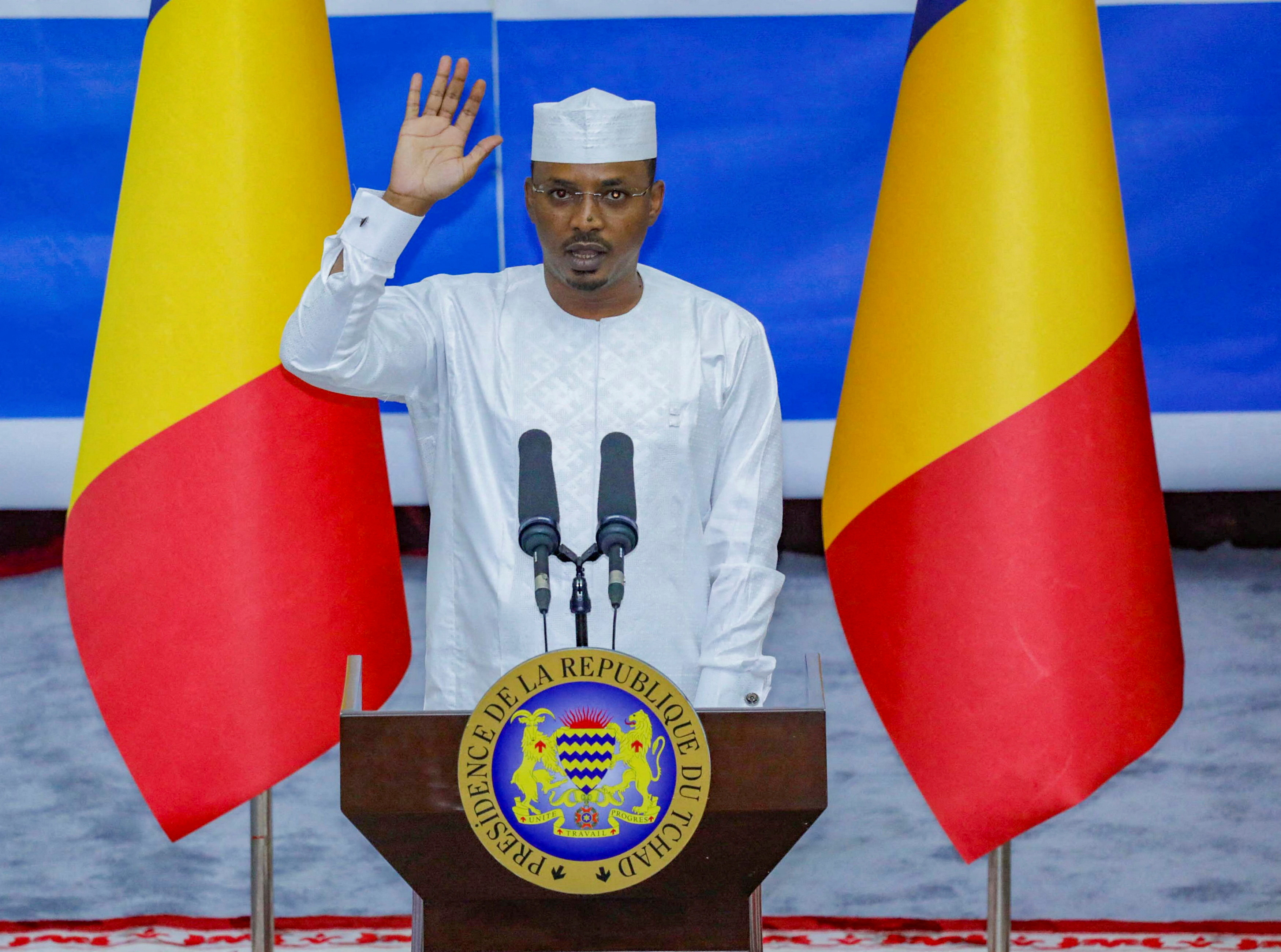 Chad's newly elected President and military leader Mahamat Idriss Deby raises his hand during his inauguration ceremony.