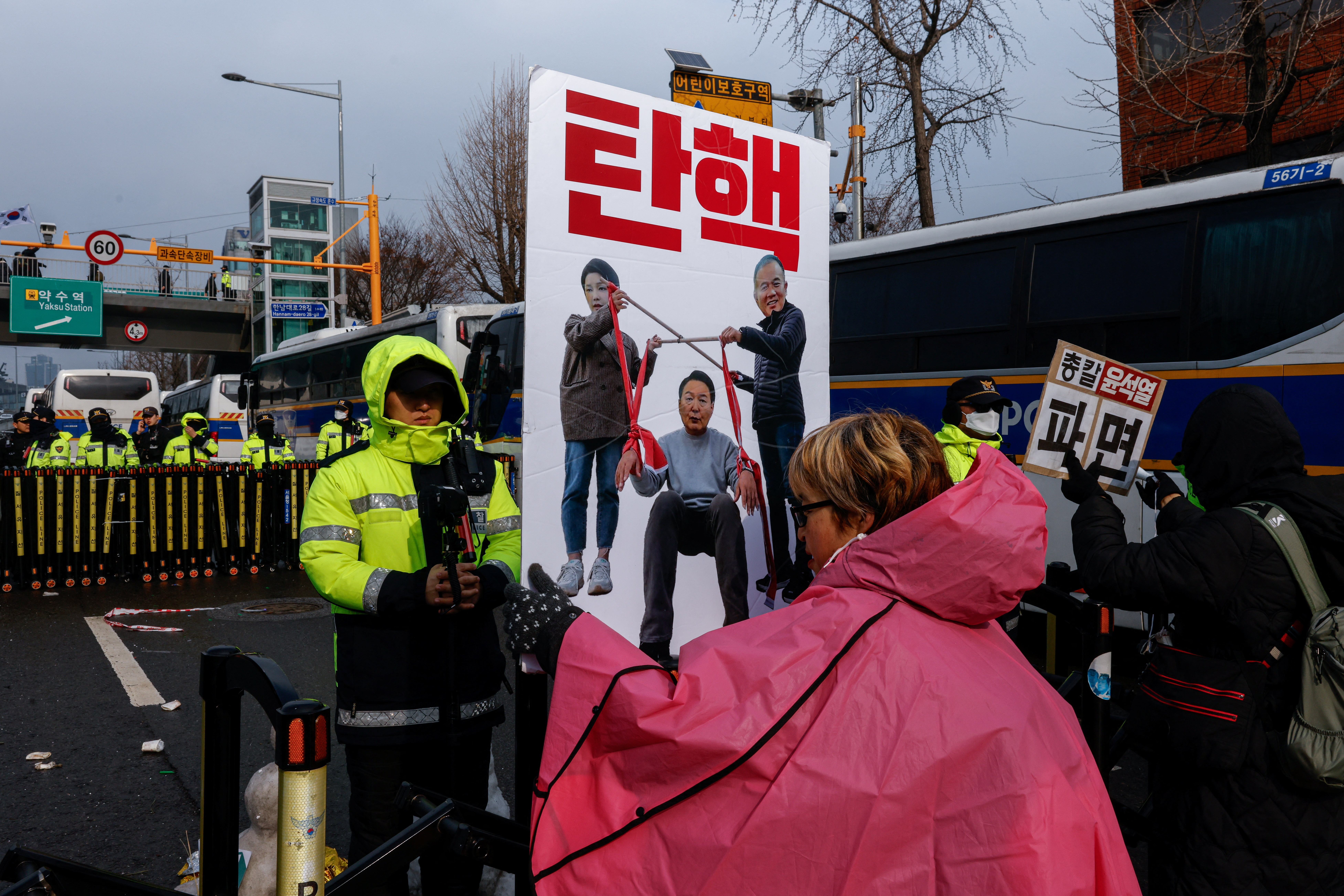 People take part in a protest against the impeached South Korean President Yoon Suk Yeol near his official residence in Seoul.