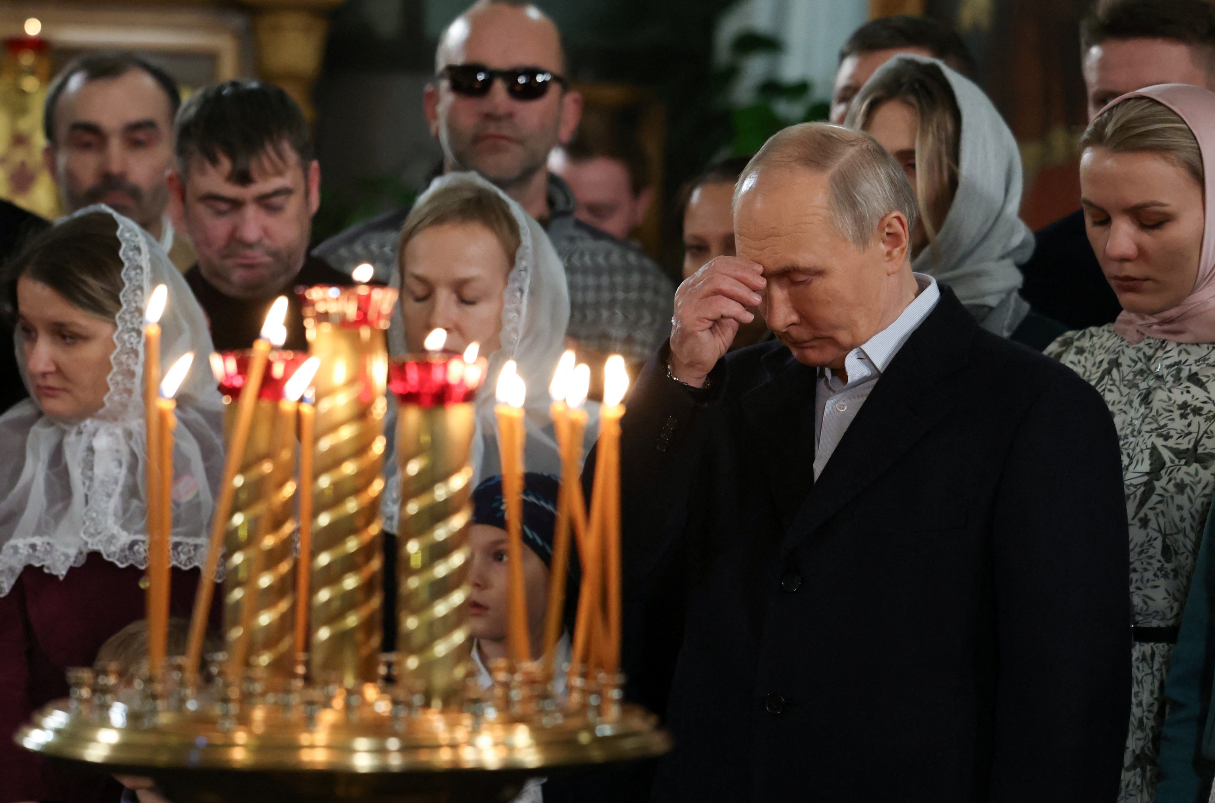Russia's President Vladimir Putin attends the Orthodox Christmas liturgy at the Church of St. George the Victorious on Poklonnaya Hill in Moscow