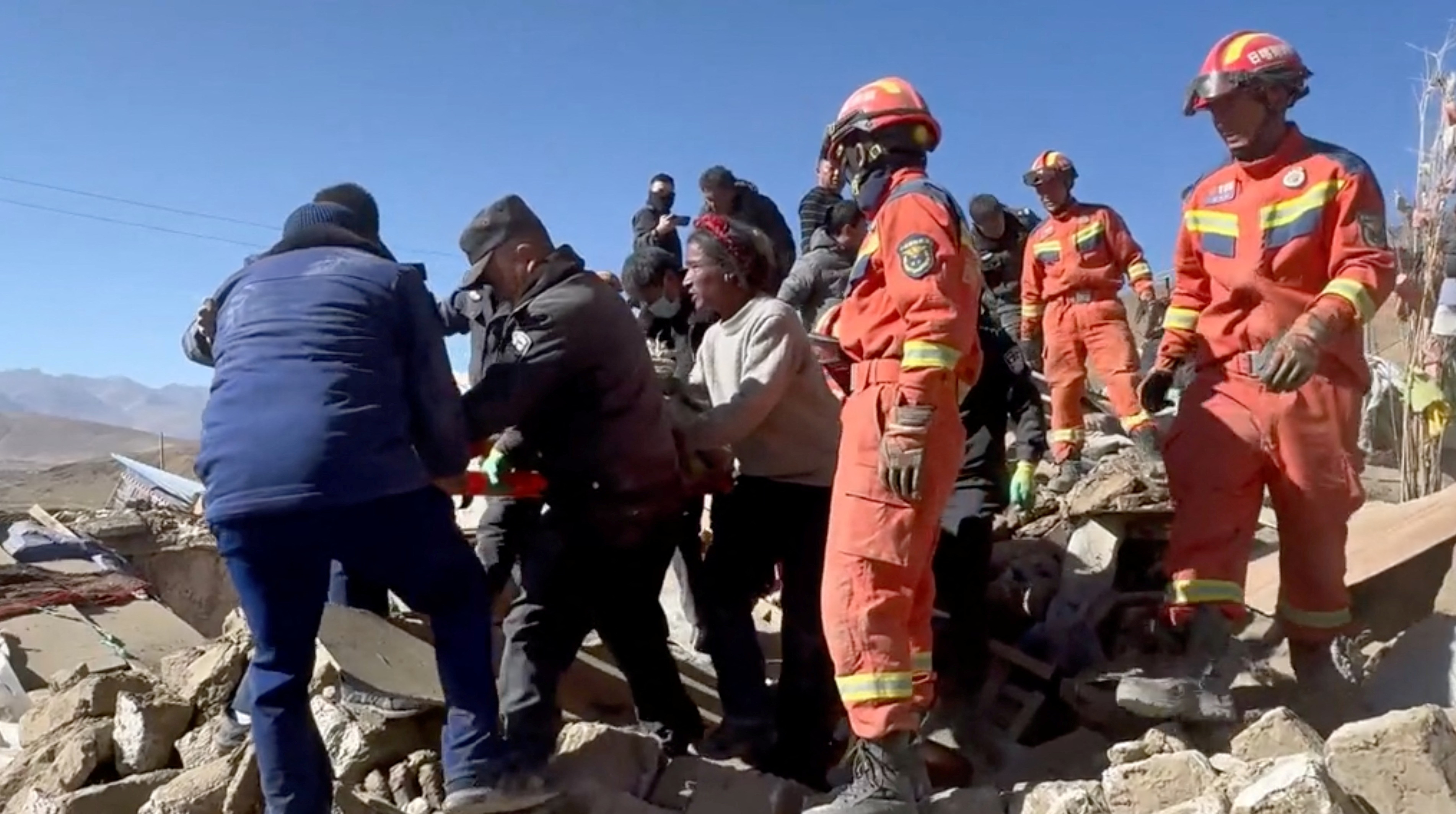 Rescue teams tend to casualties in the aftermath of an earthquake in a location given as Shigatse City, Tibet Autonomous Region, China, January 7