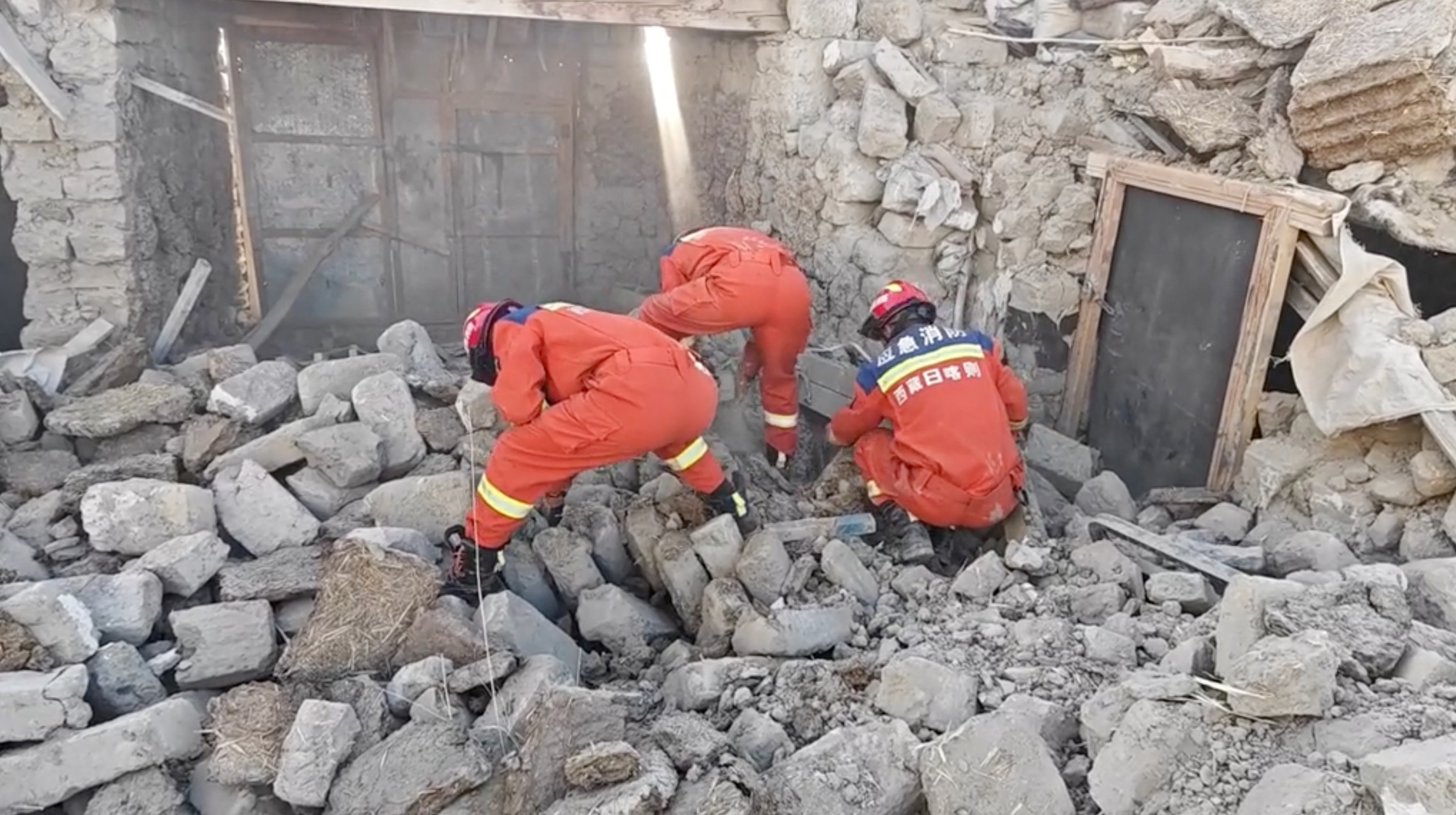 Rescue teams look through rubble in the aftermath of an earthquake in a location given as Shigatse City