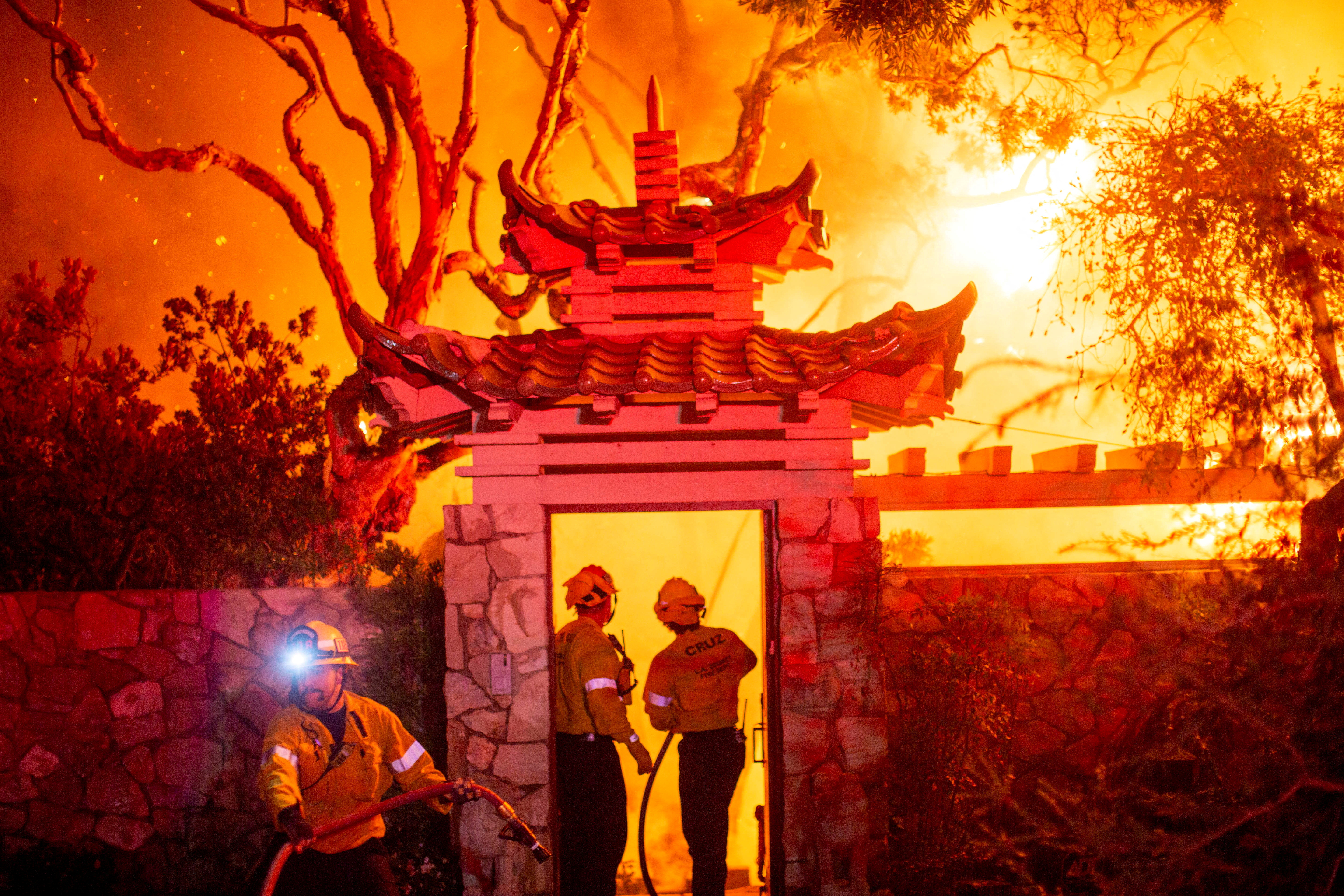 Firefighters battle the Palisades Fire as it burns during a windstorm on the west side of Los Angeles, California, U.S. January 8, 2025