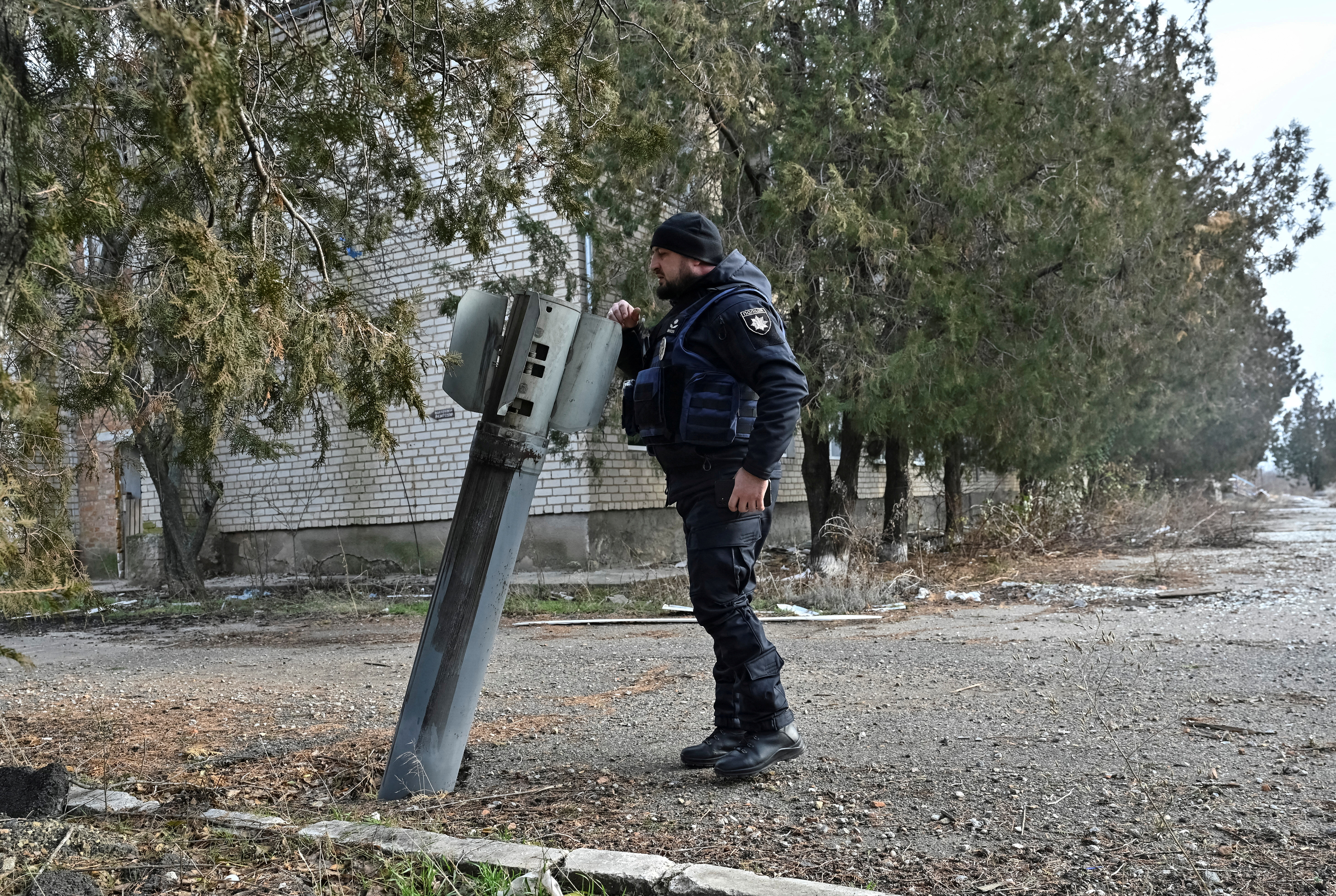 A police officer inspects the remains of a Russian rocket shell, amid Russia's attack on Ukraine, in the frontline town of Orikhiv in Zaporizhzhia region, Ukraine January 8, 2025. REUTERS/Stringer TPX IMAGES OF THE DAY
