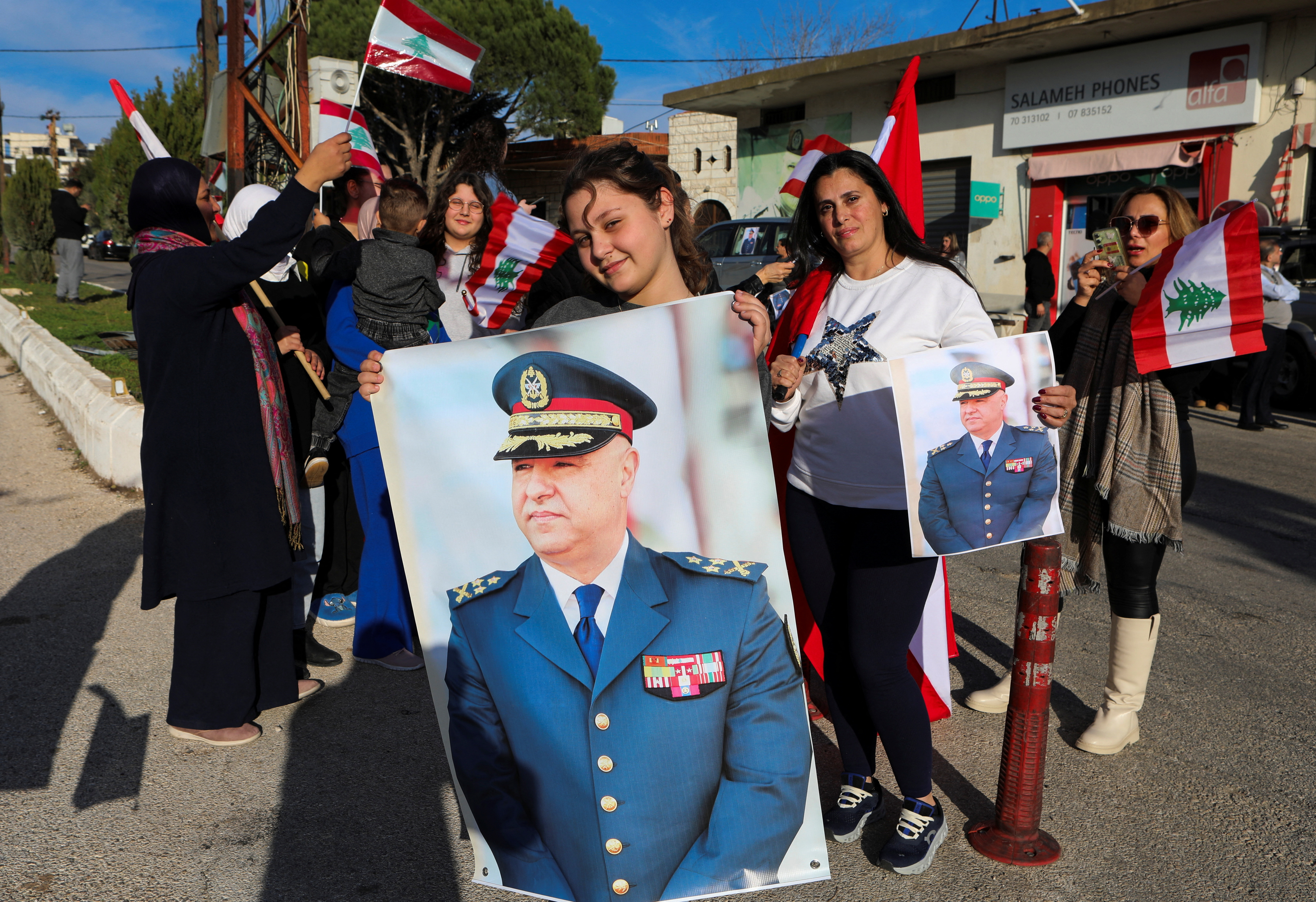 Supporters hold up a poster of new Lebanese President Joseph Aoun