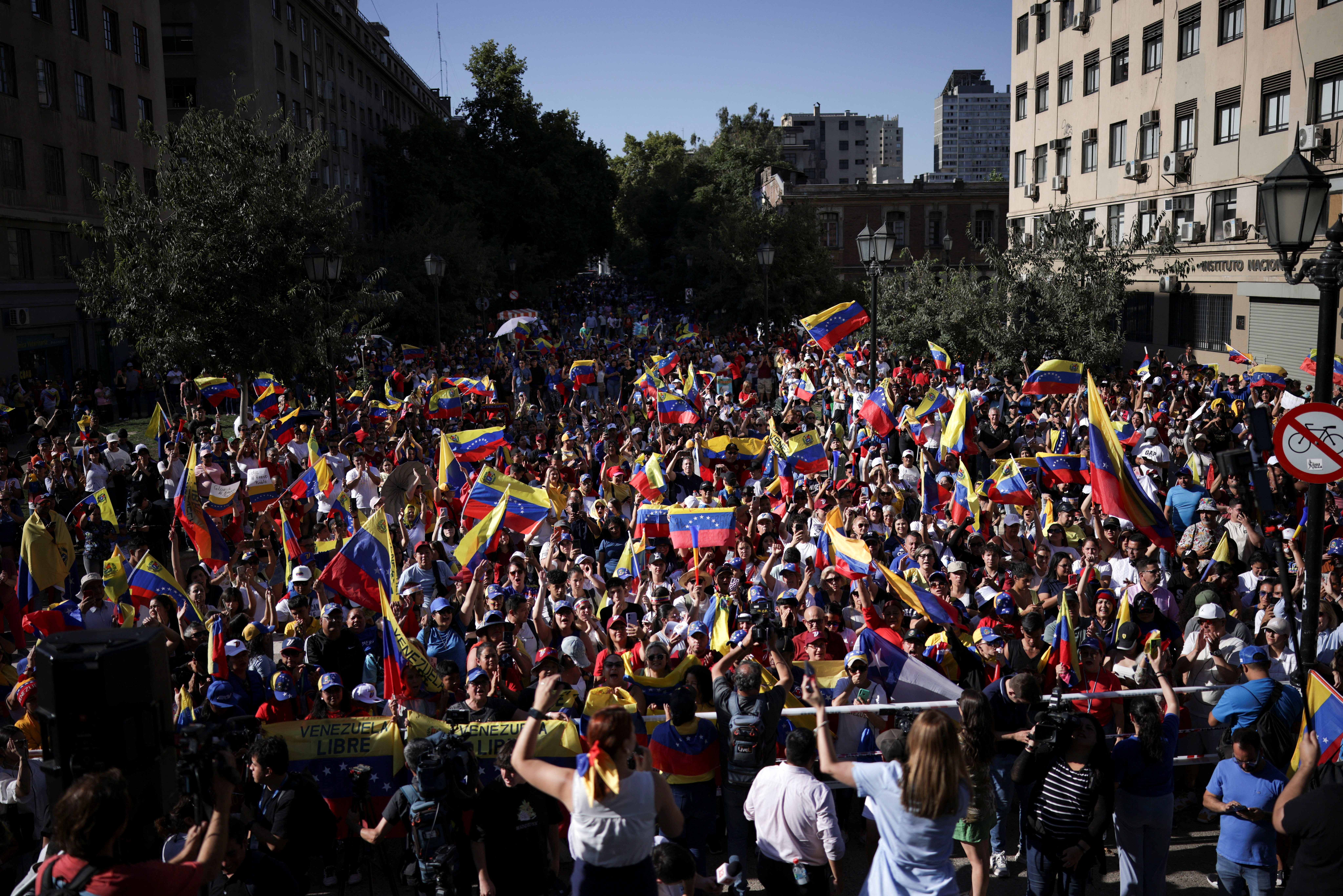 Venezuelan opposition supporters wave Venezuela's flags during a protest ahead of the Friday inauguration of President Nicolas Maduro for his third term, in Santiago, Chile January 9