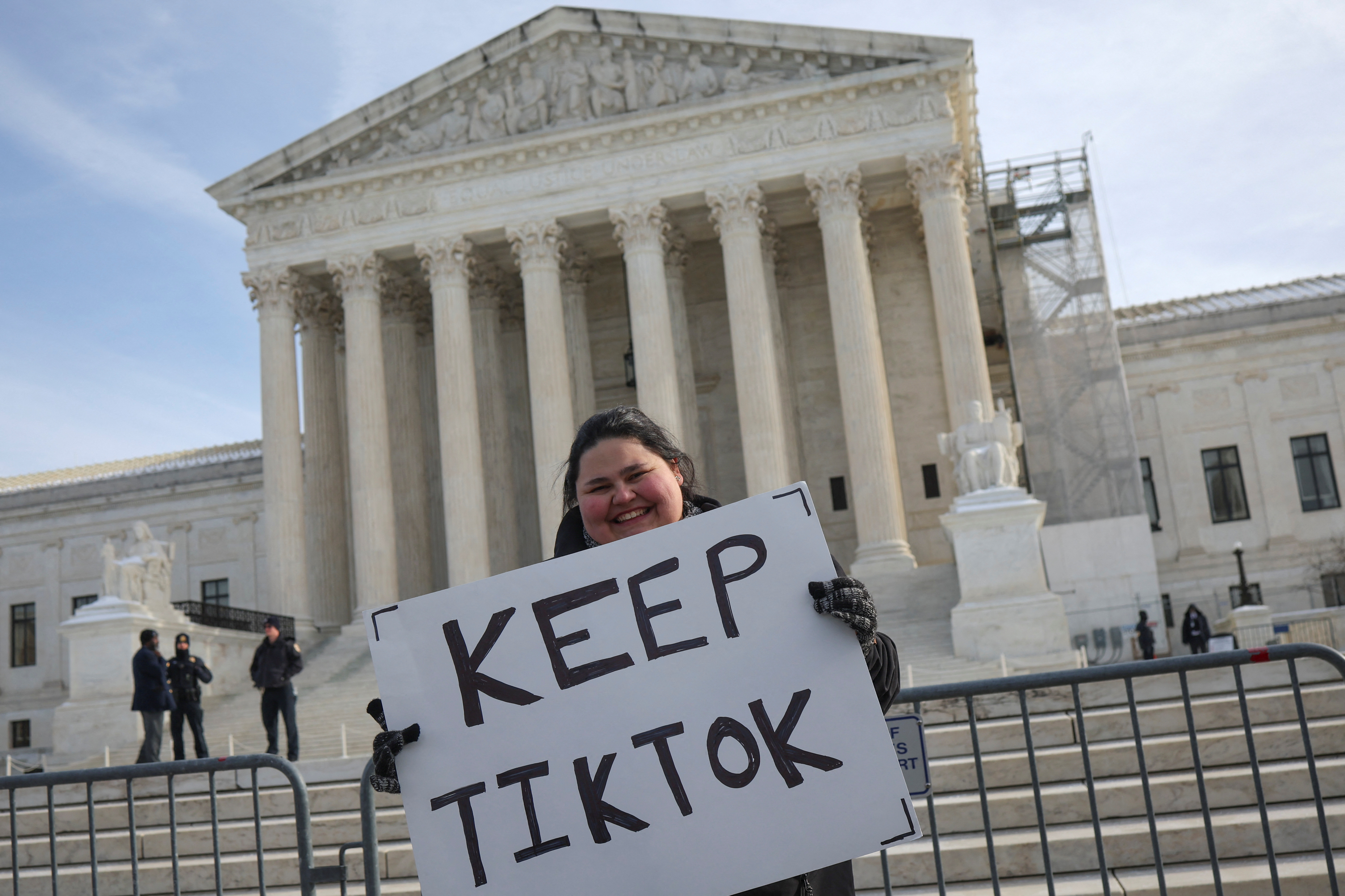 A person holds a placard in front of the Supreme Court that reads, "Keep TikTok."