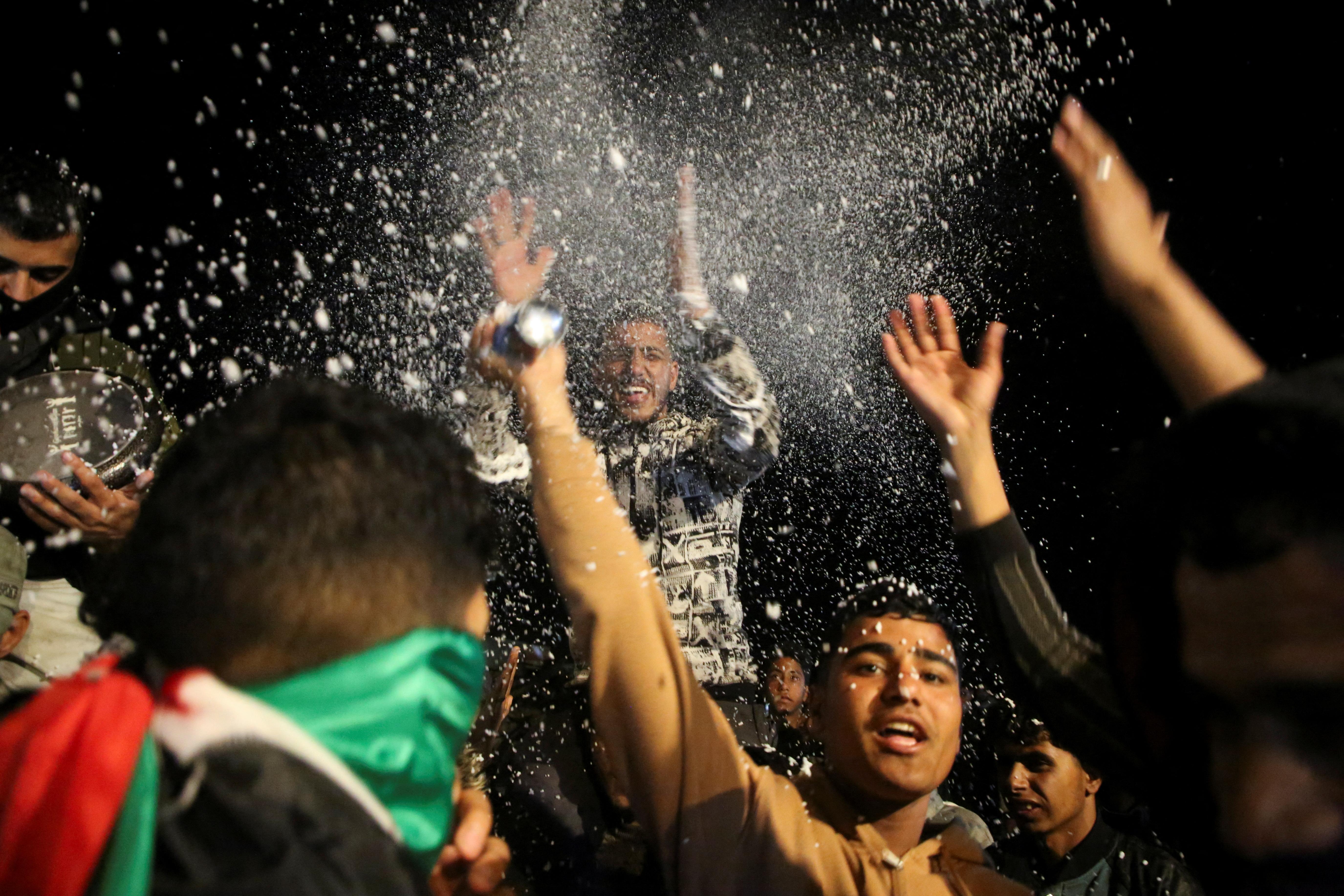 Palestinians react as they wait for news of a ceasefire deal with Israel