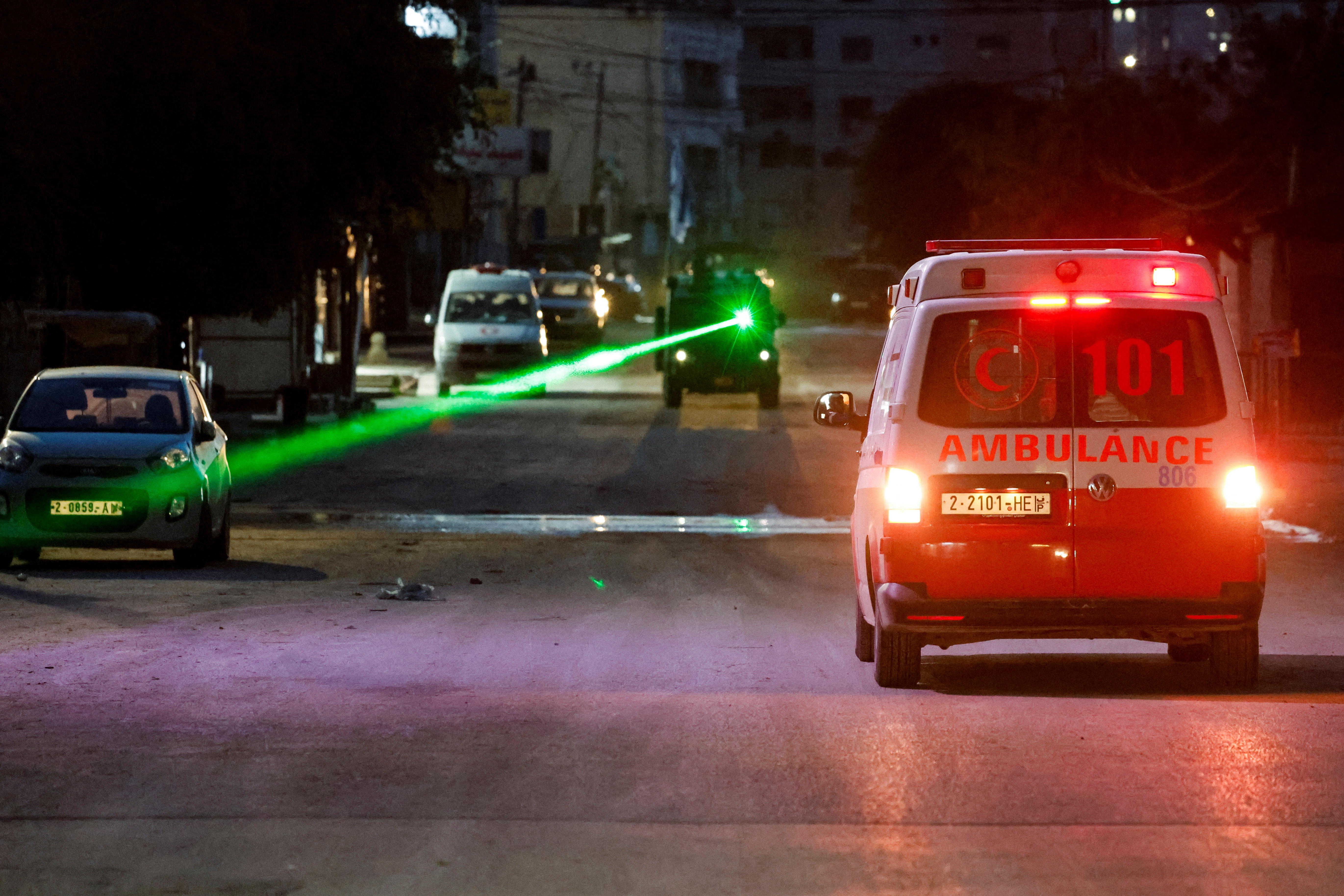 An Israeli military vehicle uses a laser near an ambulance in the Israeli-occupied West Bank, January 21, 2025. [Raneen Sawafta/Reuters]