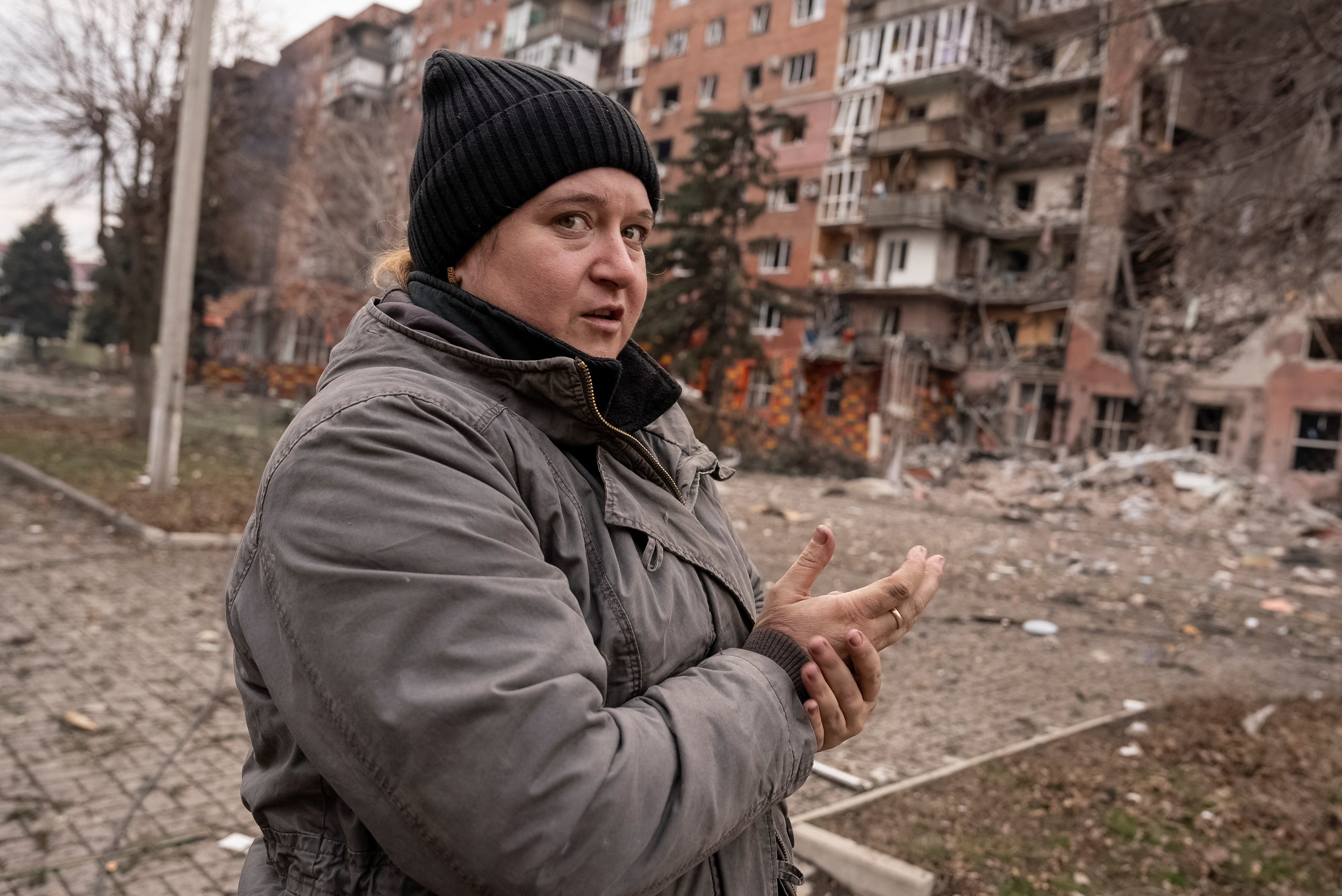A resident stands near an apartment building damaged by Russian military strikes, amid Russia's attack on Ukraine, in the town of Pokrovsk in Donetsk region, Ukraine January 21, 2025. REUTERS/Inna Varenytsia
