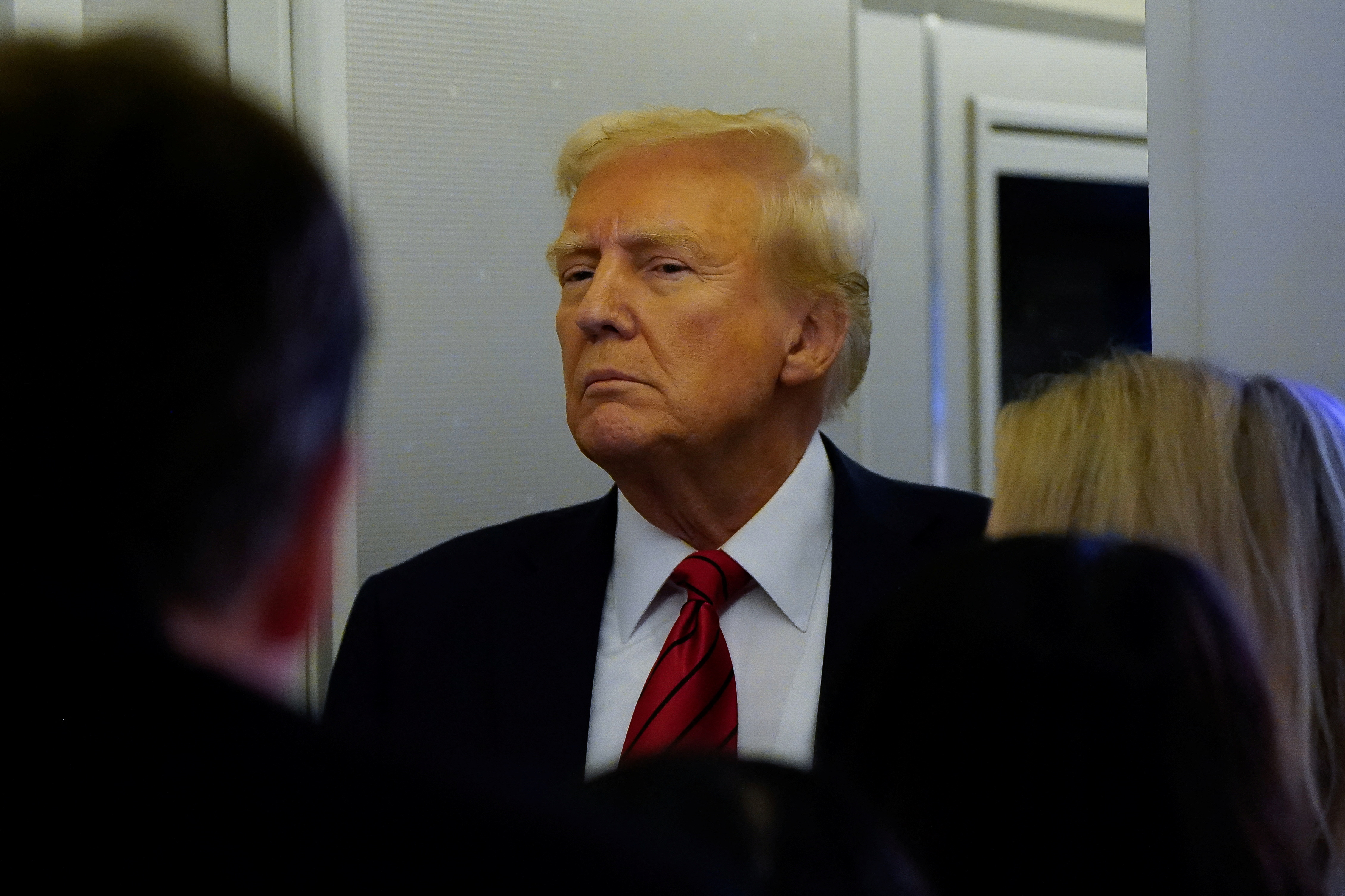 U.S. President Donald Trump looks on as he speaks to reporters aboard Air Force One before arriving at Joint Base Andrews, Maryland, U.S., January 27, 2025.