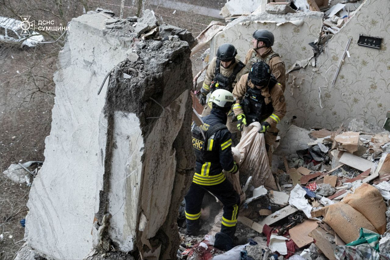 Rescuers work at a site of an apartment building damaged during a Russian drone strike,