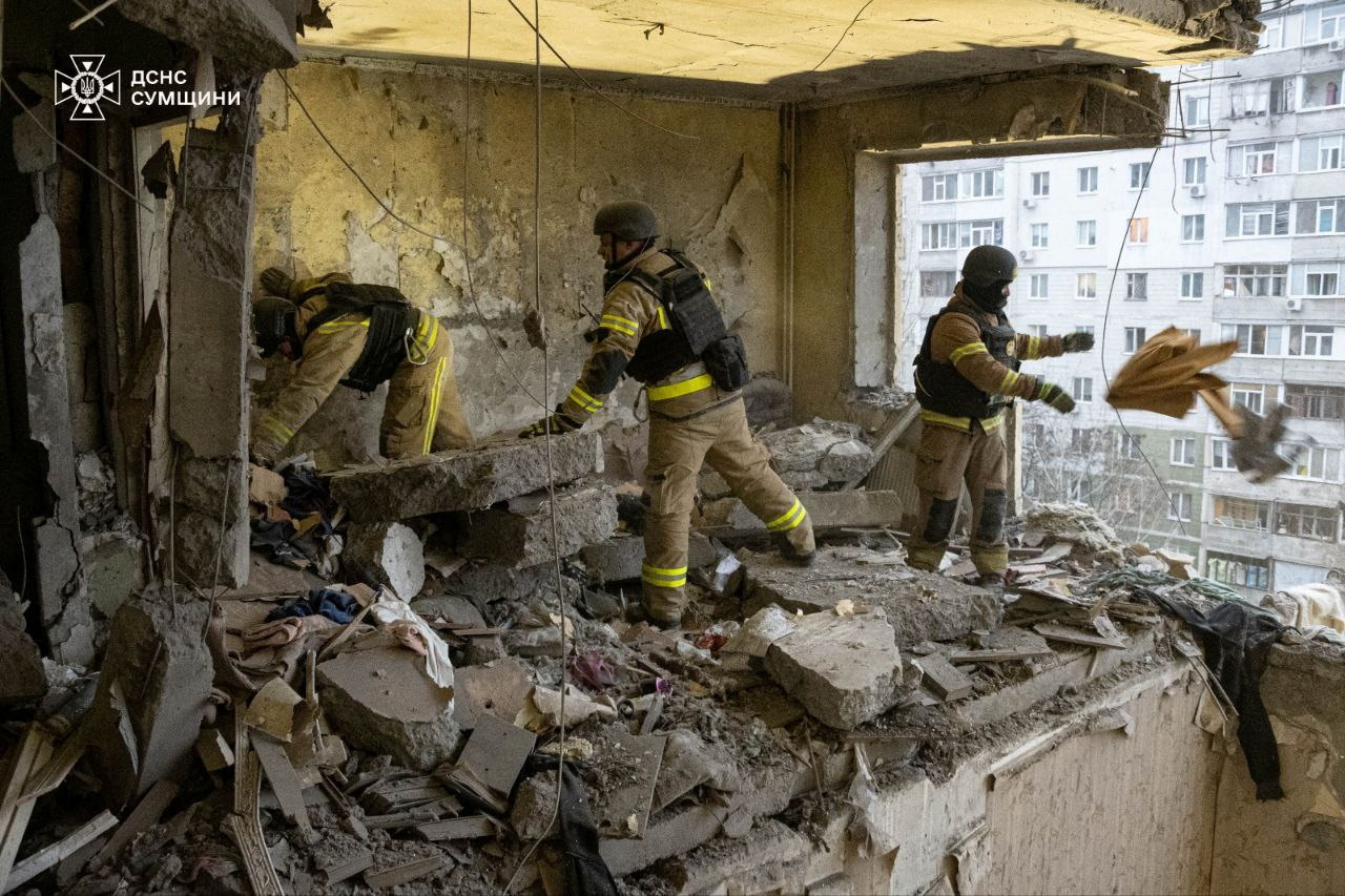 Rescuers work at a site of an apartment building damaged during a Russian drone strike,