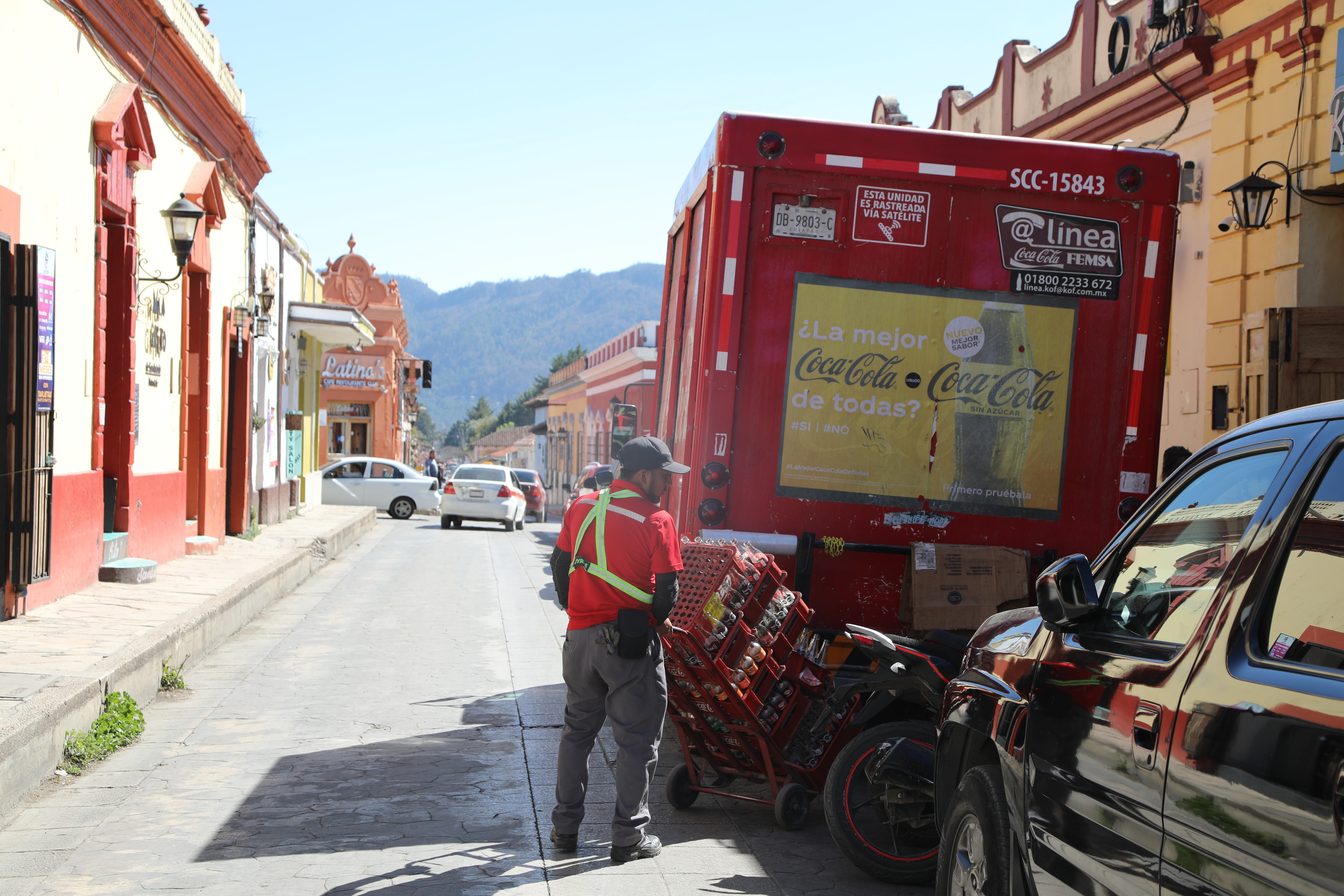 A delivery truck driver parks a Coca-Cola branded van in San Cristobal, Mexico