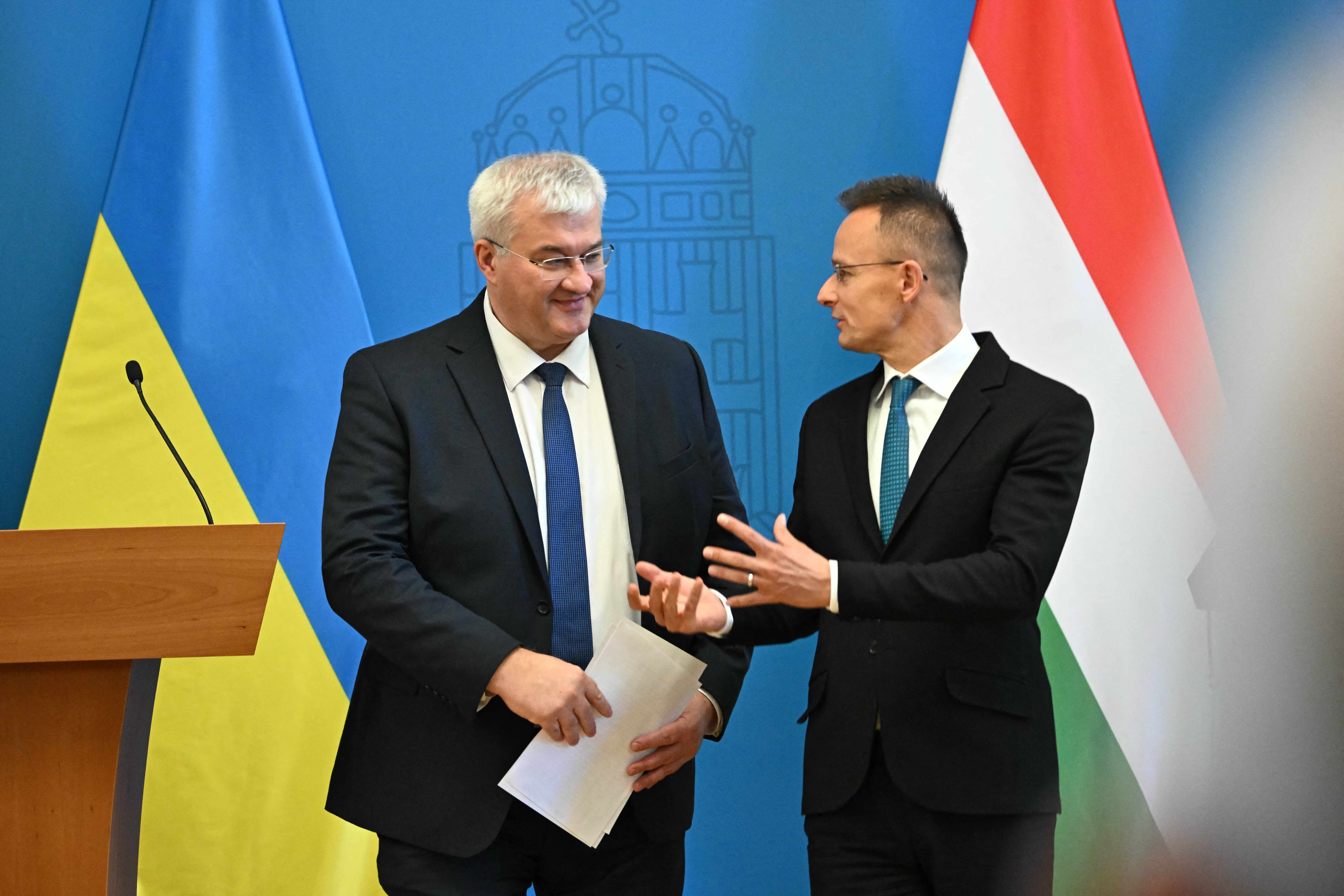 Hungarian Foreign and Trade Minister Peter Szijjarto (R) and Ukrainian Foreign Minister Andrii Sybiha chat at the end of a joint press conference at the Foreign Office in Budapest, Hungary, on September 30, 2024. The Ukrainian guest pays a one-day official visit to the Hungarian capital. (Photo by Attila KISBENEDEK / AFP)