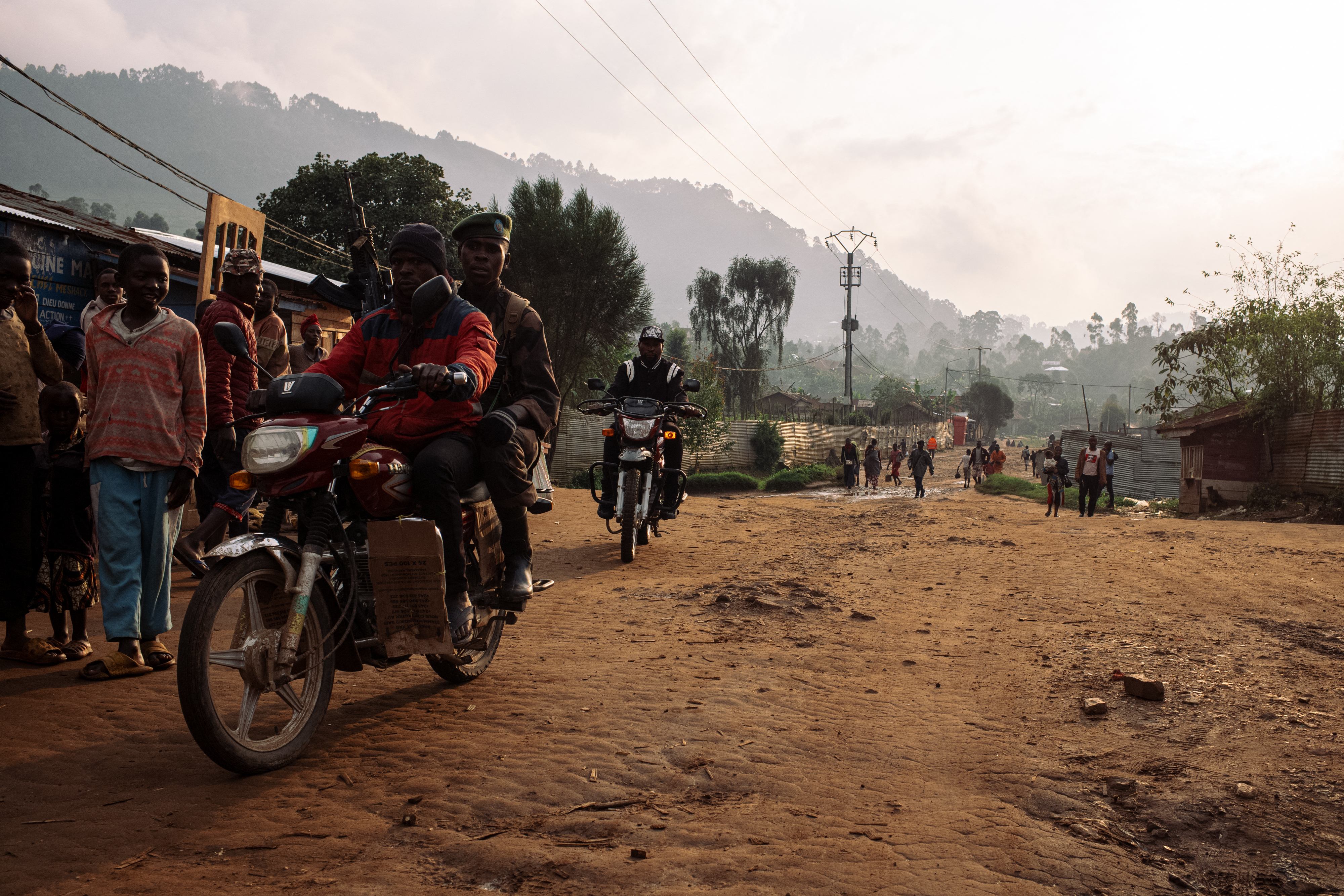 A soldier of the Armed Forces of the DRC (FARDC) rides on a motorbike in a street in the town of Lubero, North Kivu, [File: Philemon Barbier / AFP]