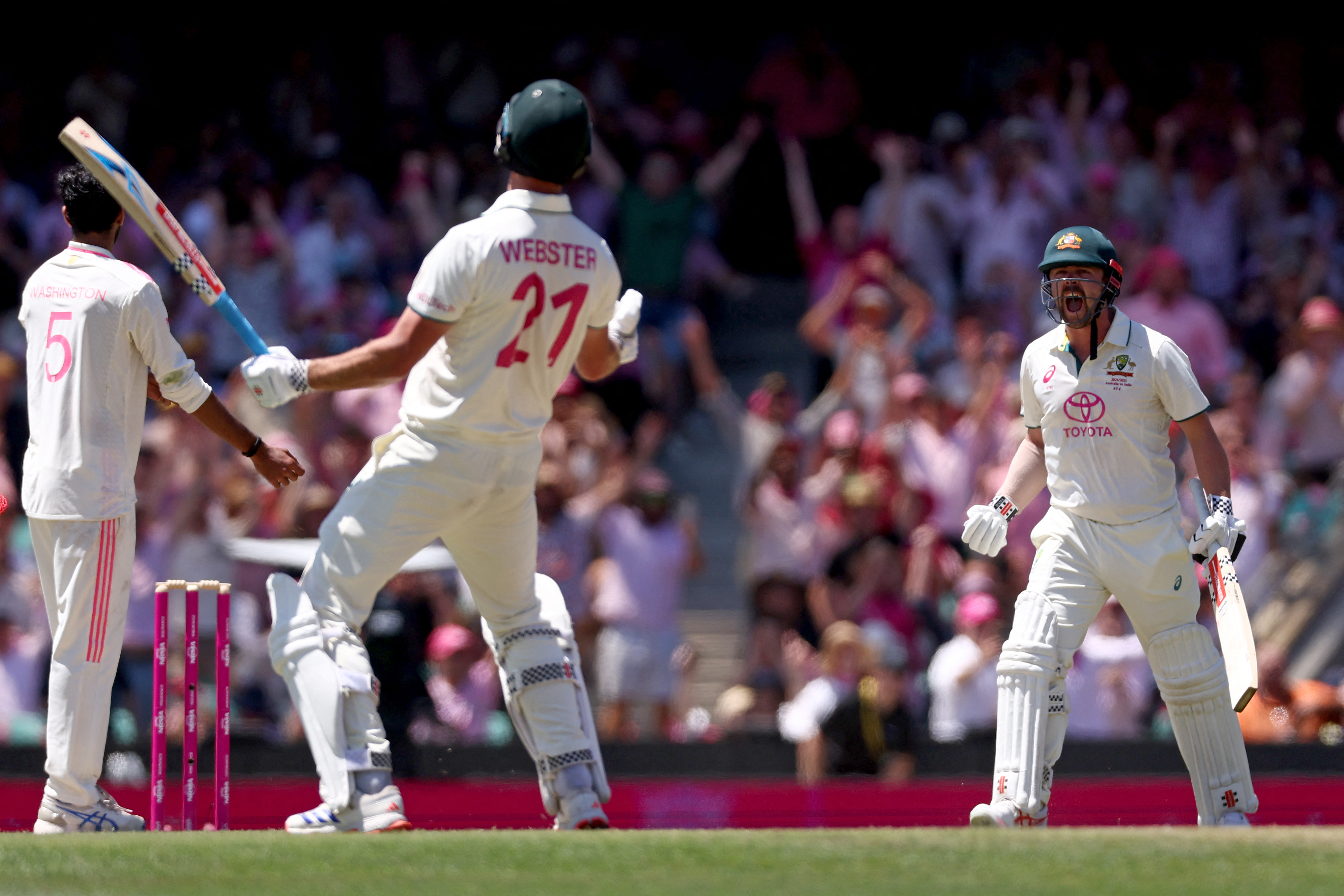 Australias Travis Head (R) and teammate Beau Webster react after they won the match on day three of the fifth cricket Test match between Australia and India at The SCG in Sydney on January 5, 2025. (Photo by DAVID GRAY / AFP) / -- IMAGE RESTRICTED TO EDITORIAL USE - STRICTLY NO COMMERCIAL USE --