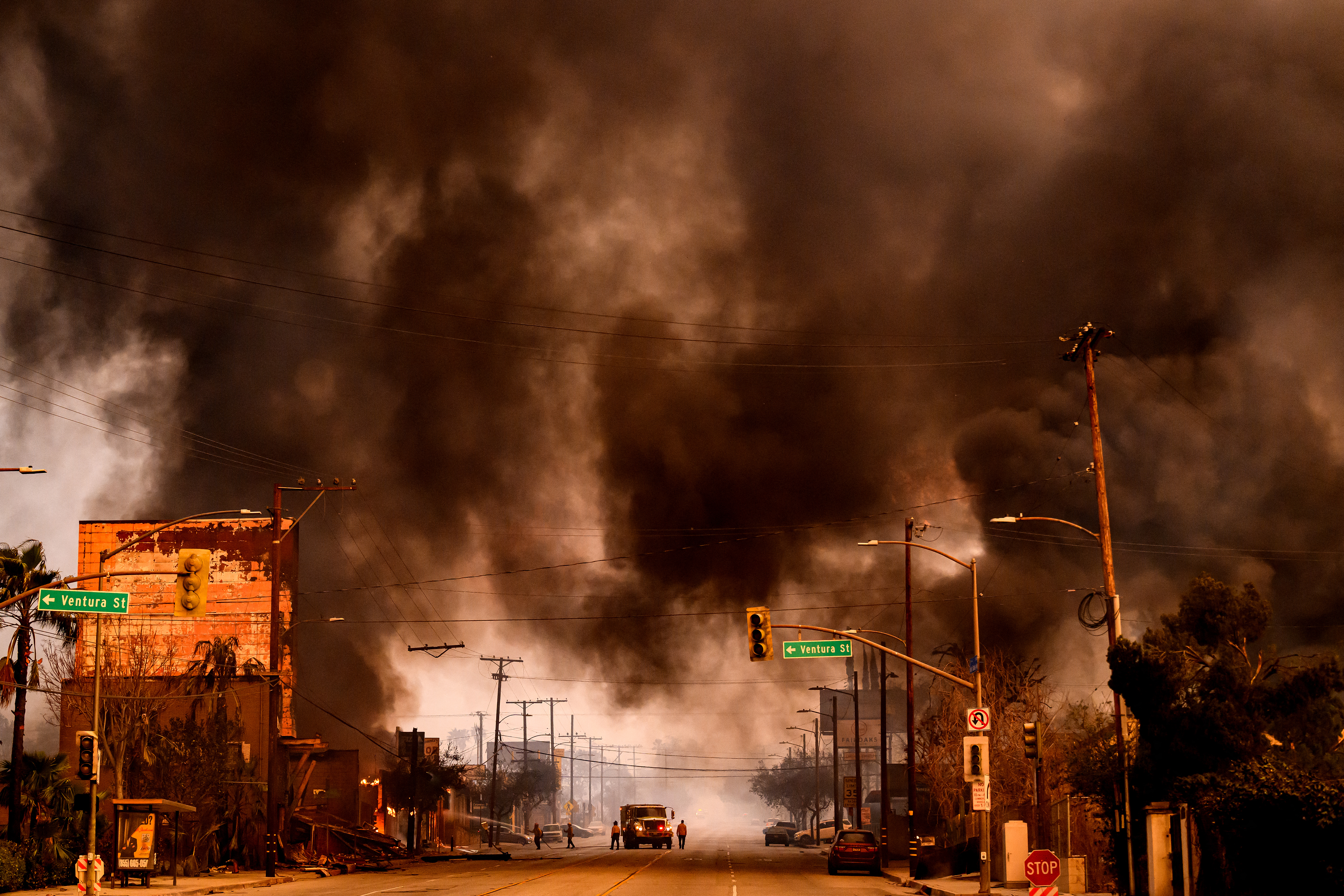Smokes and flames overwhelms a commercial area during the Eaton fire in the Altadena area of Los Angeles County, California on January 8