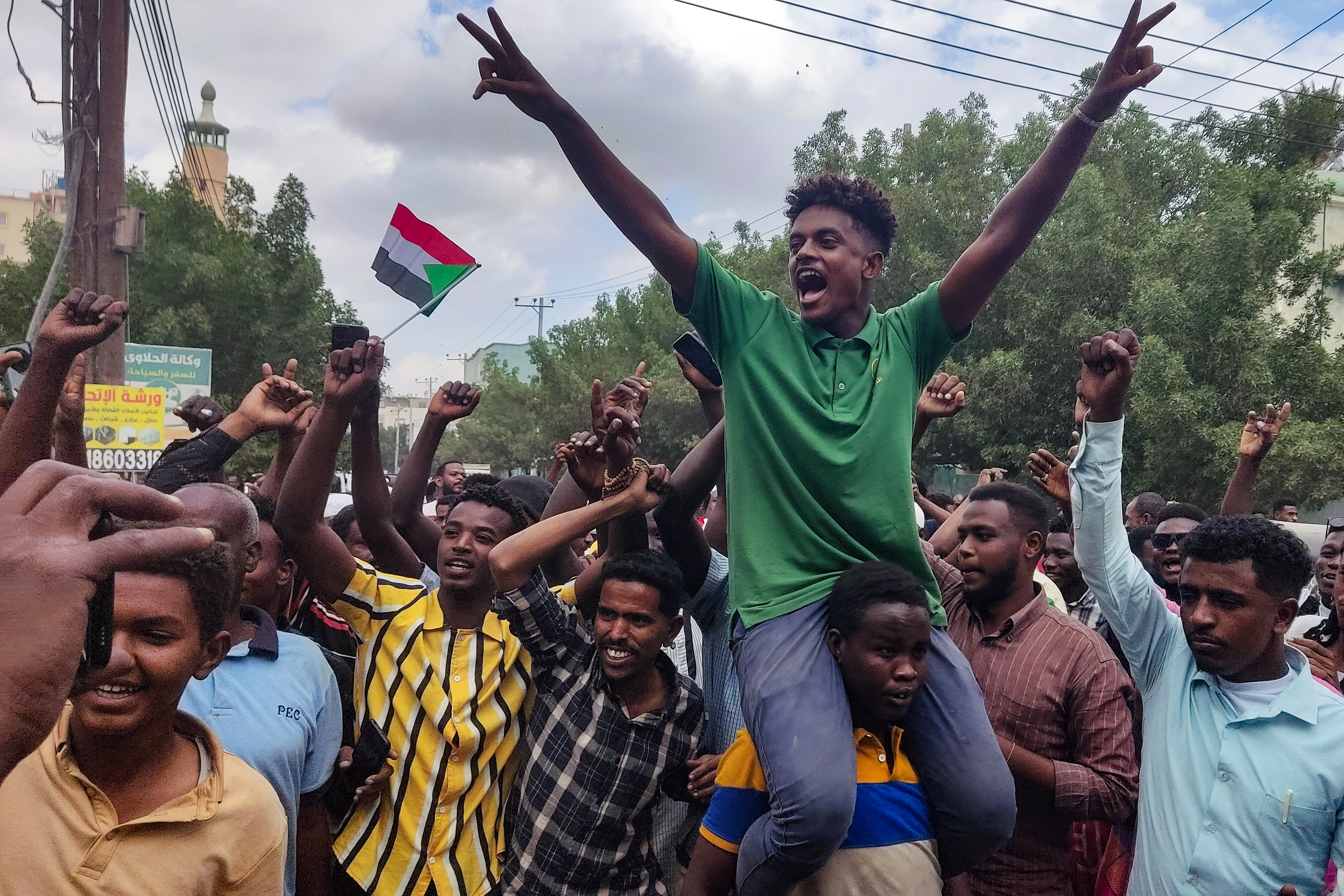 People take to the streets in Port Sudan to celebrate the reported advance of Sudanese forces on the key Gezira state capital