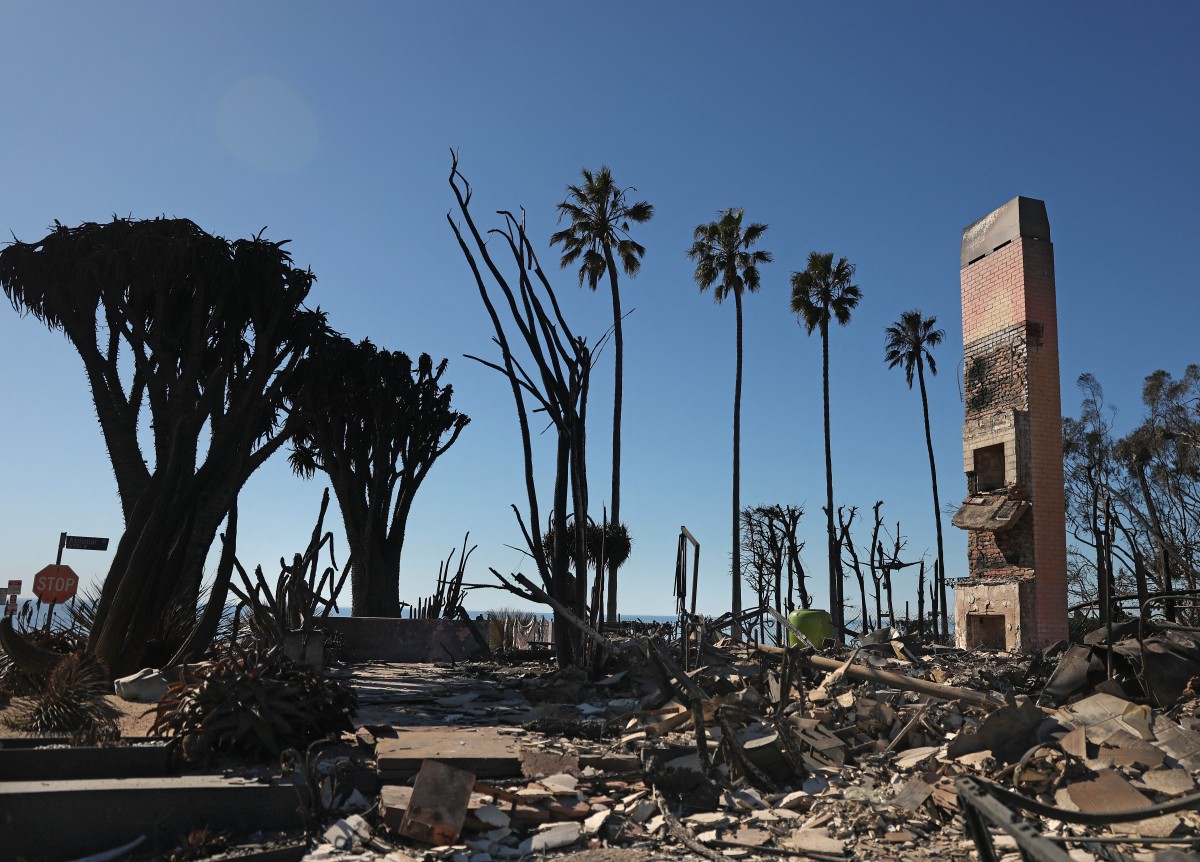 A chimney remains at the site of a home that was destroyed by the Palisades Fire