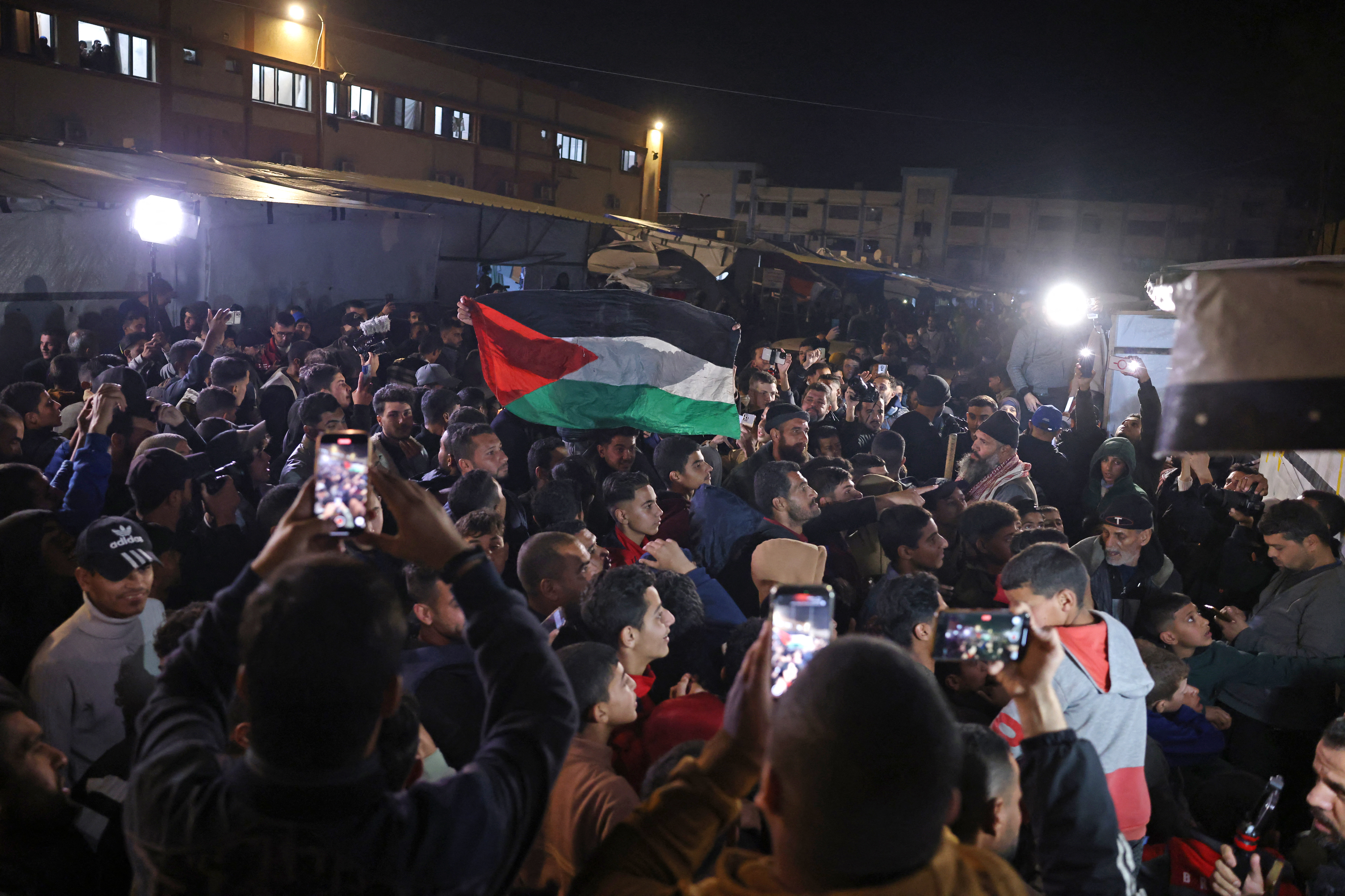 Palestinians react as they wait for news of a ceasefire deal with Israel