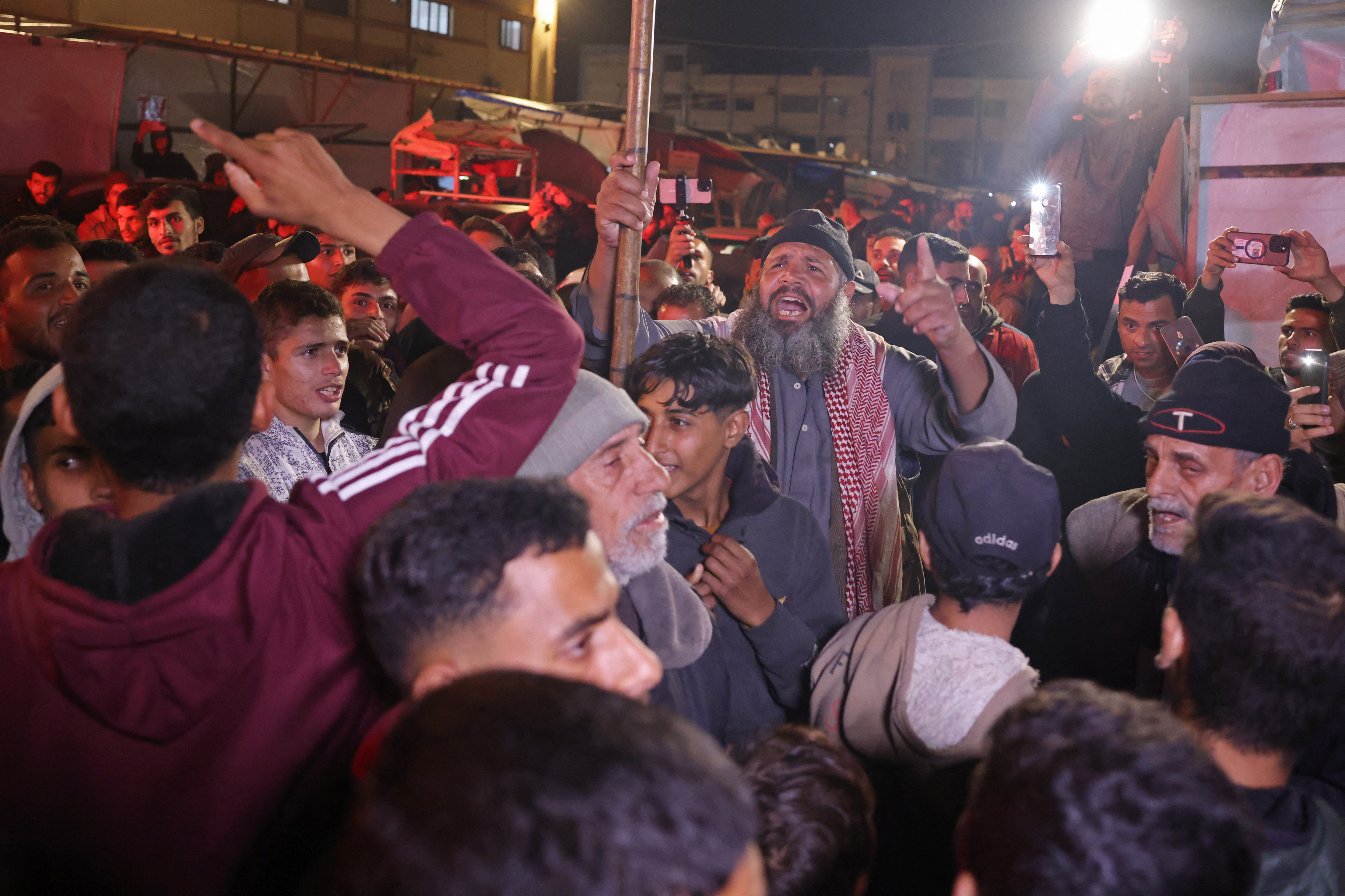 Palestinians react as they wait for news of a ceasefire deal with Israel