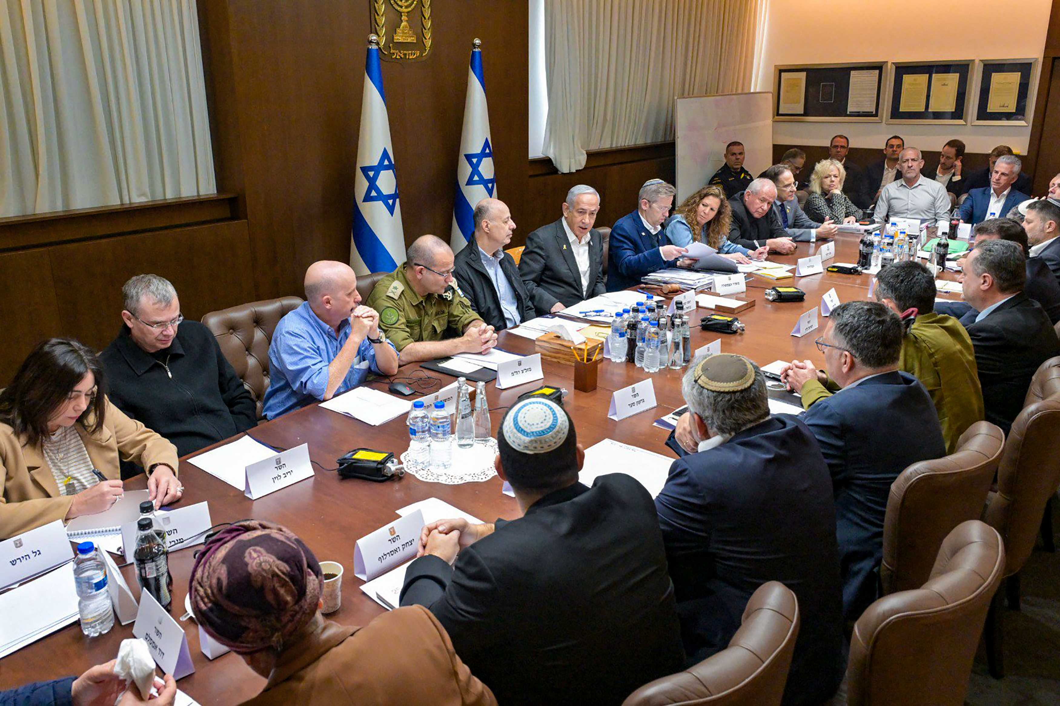 This handout picture released by the Israeli Government Press Office (GPO) shows Prime Minister Benjamin Netanyahu (6-L), heading a security cabinet meeting to vote on a Gaza ceasefire and hostage release deal that should take effect ton January 19, in Jerusalem on January 17, 2025. If approved, the agreement would halt fighting and bombardment in Gaza's deadliest-ever war and initiate on Sunday the release of dozens of hostages held in the territory since Hamas's October 7, 2023 attack on Israel. (Photo by Koby Gideon / GPO / AFP) / Israel OUT / ISRAEL OUT / ISRAEL OUT / XGTY / === RESTRICTED TO EDITORIAL USE - MANDATORY CREDIT "AFP PHOTO / HANDOUT /GPO' - NO MARKETING NO ADVERTISING CAMPAIGNS - DISTRIBUTED AS A SERVICE TO CLIENTS ==