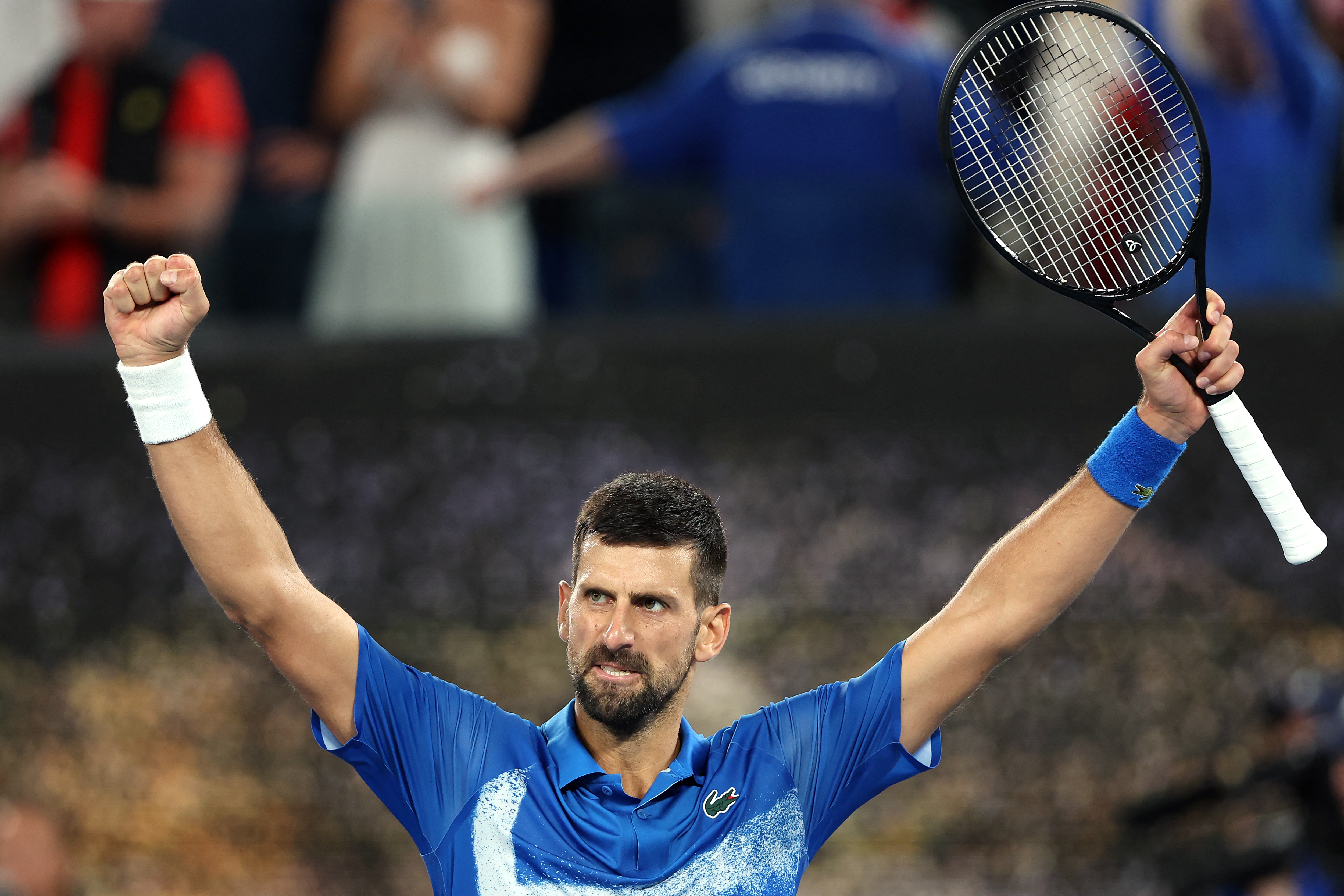 Serbia's Novak Djokovic celebrates victory over Spain's Carlos Alcaraz after their men's singles quarterfinal match on day ten of the Australian Open tennis tournament in Melbourne on January 22, 2025. (Photo by Martin KEEP / AFP) / -- IMAGE RESTRICTED TO EDITORIAL USE - STRICTLY NO COMMERCIAL USE --
