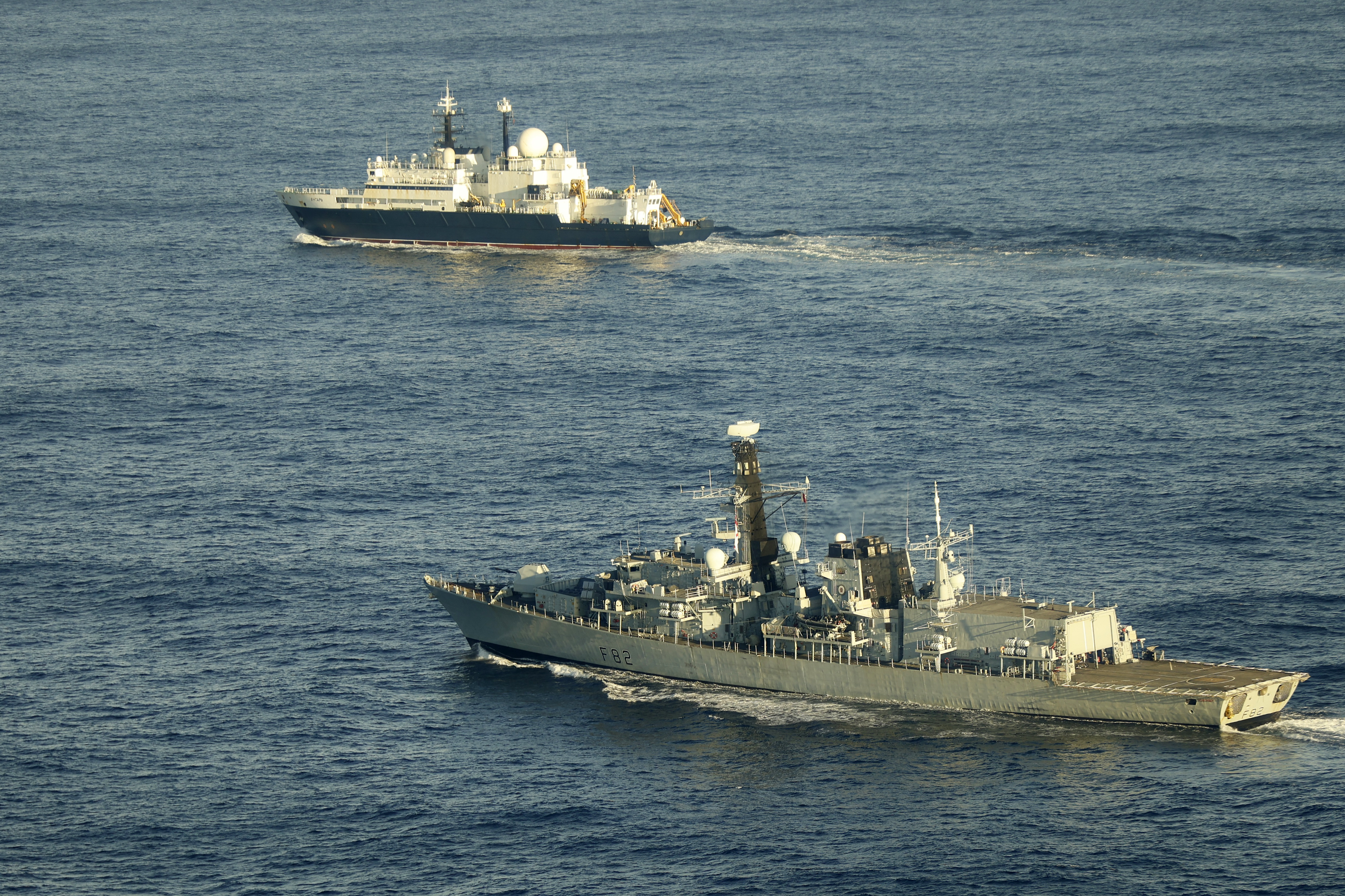 Royal Navy Type 23 frigate HMS Somerset (foreground) patrolling near the Russian vessel Yantar