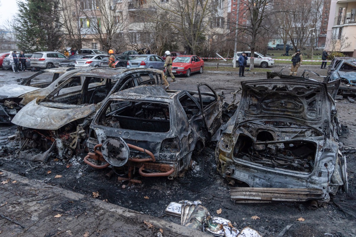 This photograph shows burnt-out cars parked in the courtyard of a residential building following a missile attack in Odesa on January 28, 2025. (Photo by Oleksandr GIMANOV / AFP)