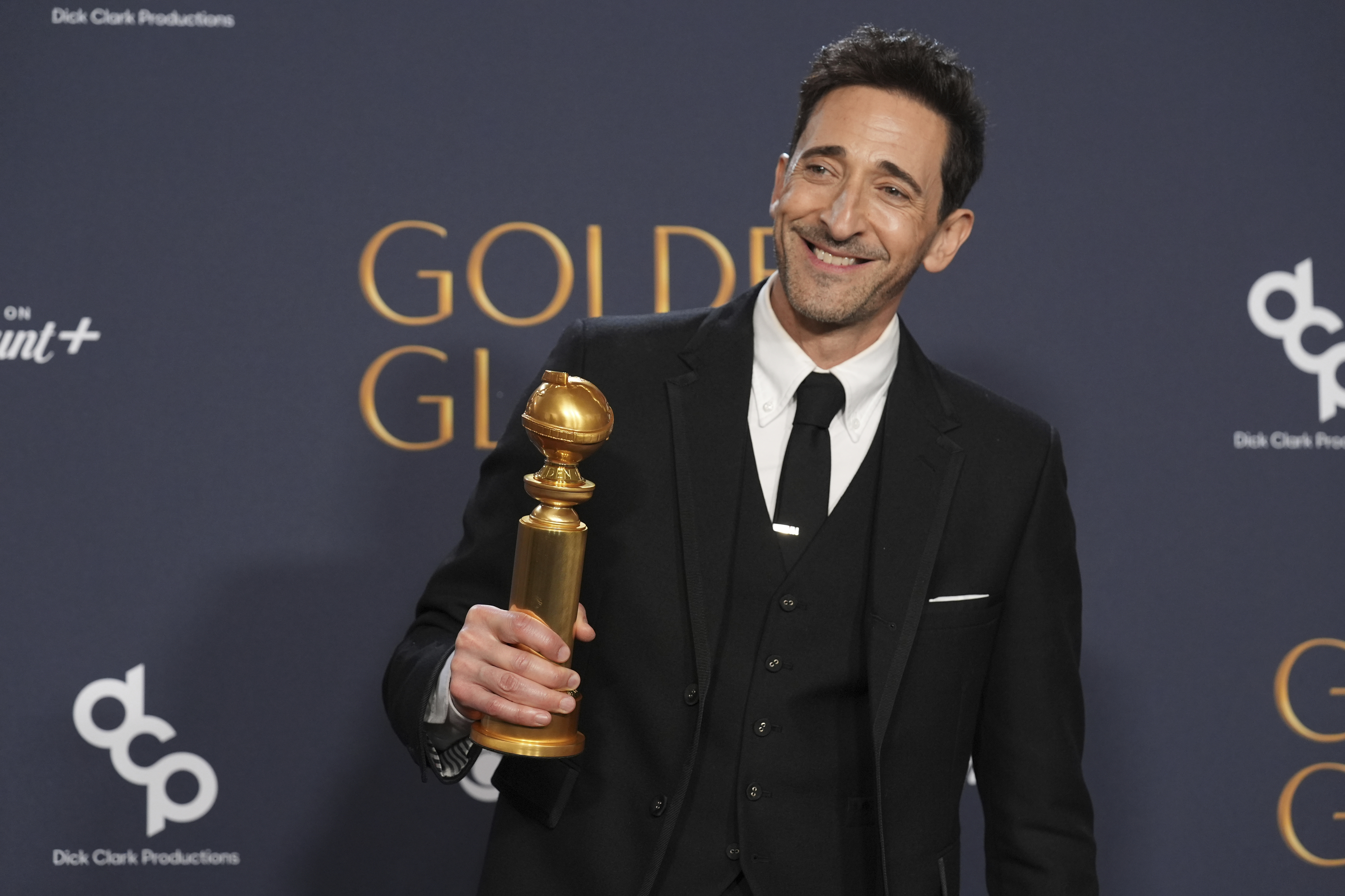 Adrien Brody poses in the press room with the award for best performance by a male actor in a motion picture - drama for "The Brutalist" during the 82nd Golden Globes on Sunday, Jan. 5, 2025, at the Beverly Hilton in Beverly Hills, Calif. (AP Photo/Chris Pizzello)