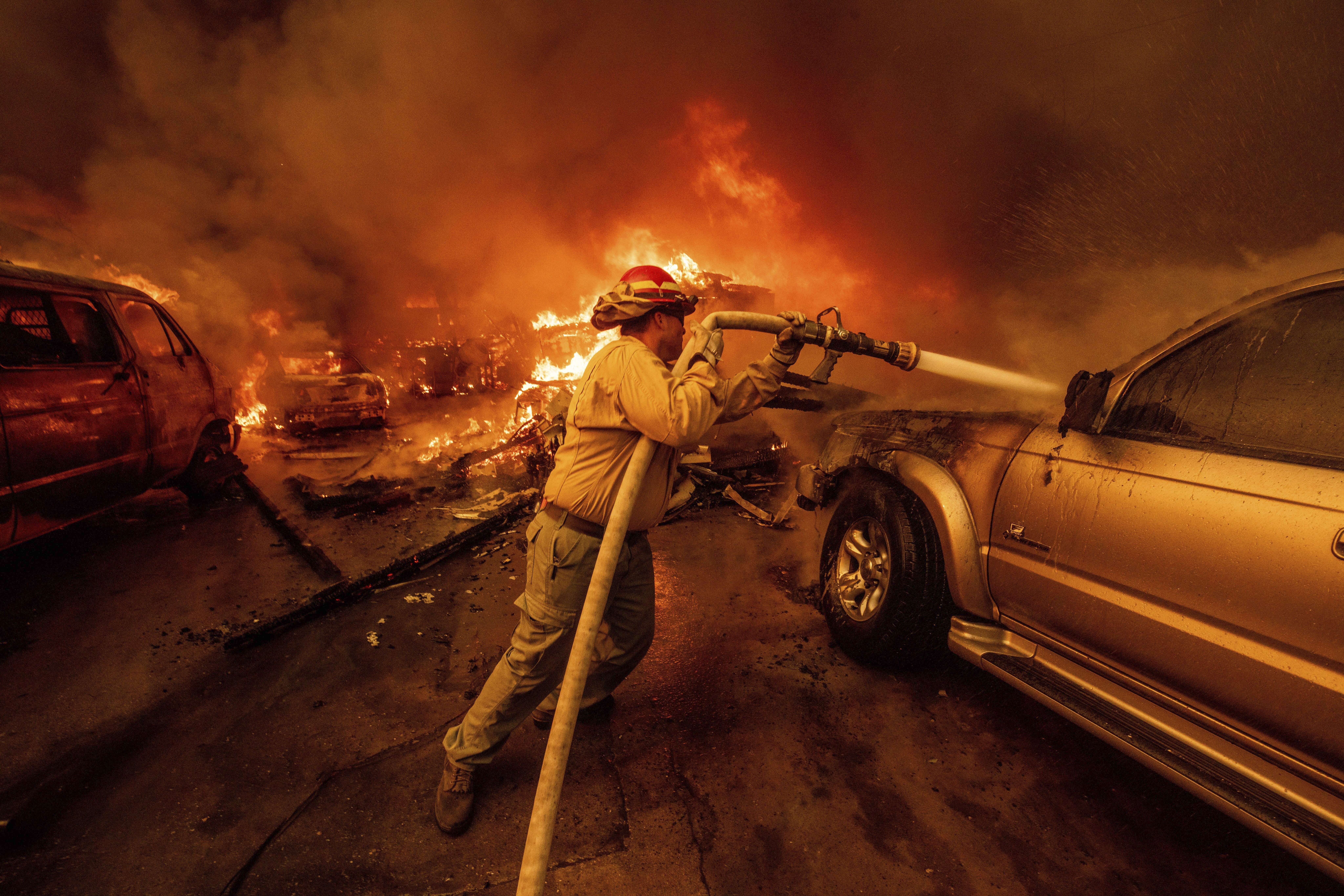 A firefighter battles the Eaton Fire Wednesday, Jan. 8