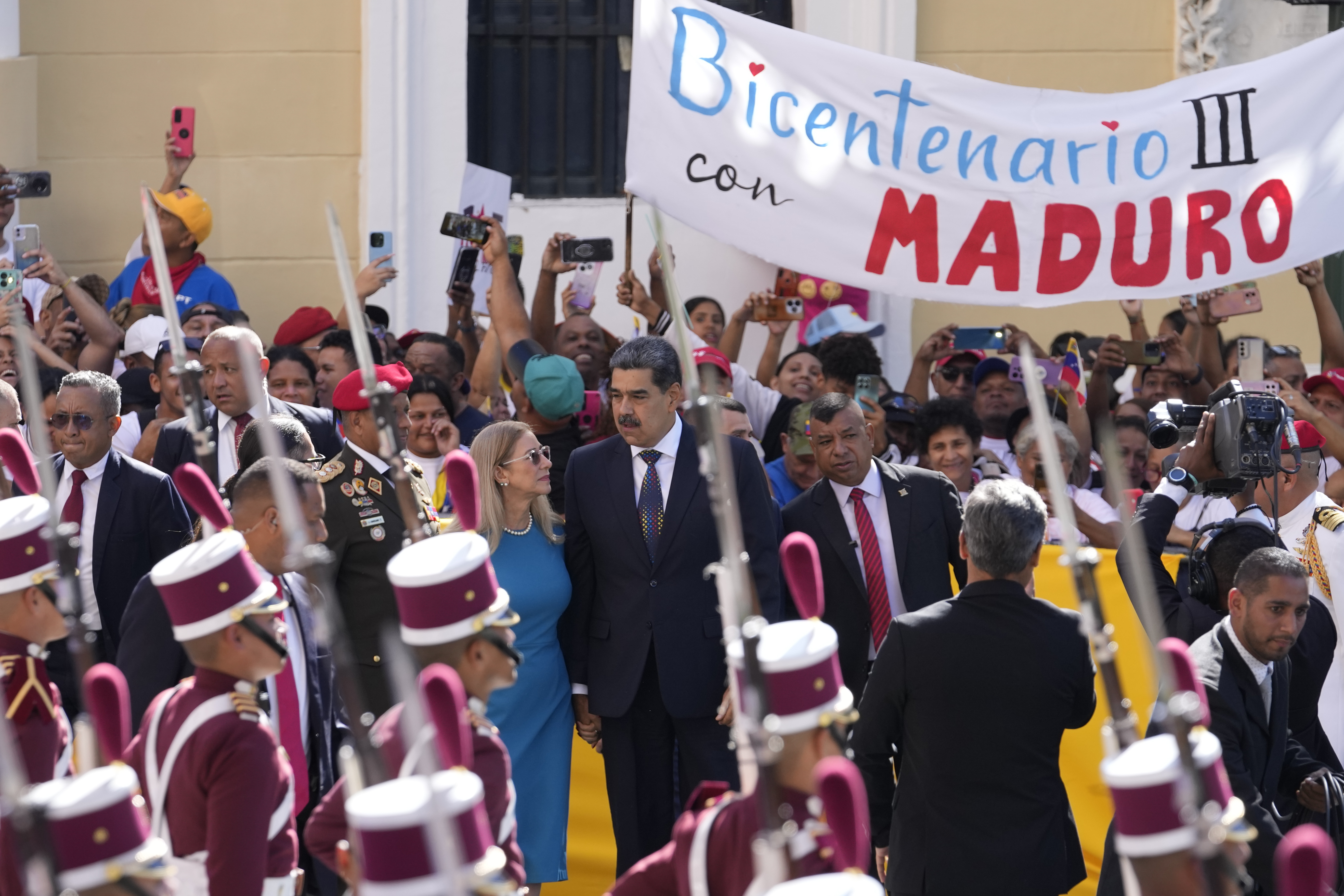 Venezuelan President Nicolas Maduro and his wife Cilia Flores arrive at the National Assembly for his swear-in ceremony for a third term in Caracas, Venezuela, Friday, Jan. 10