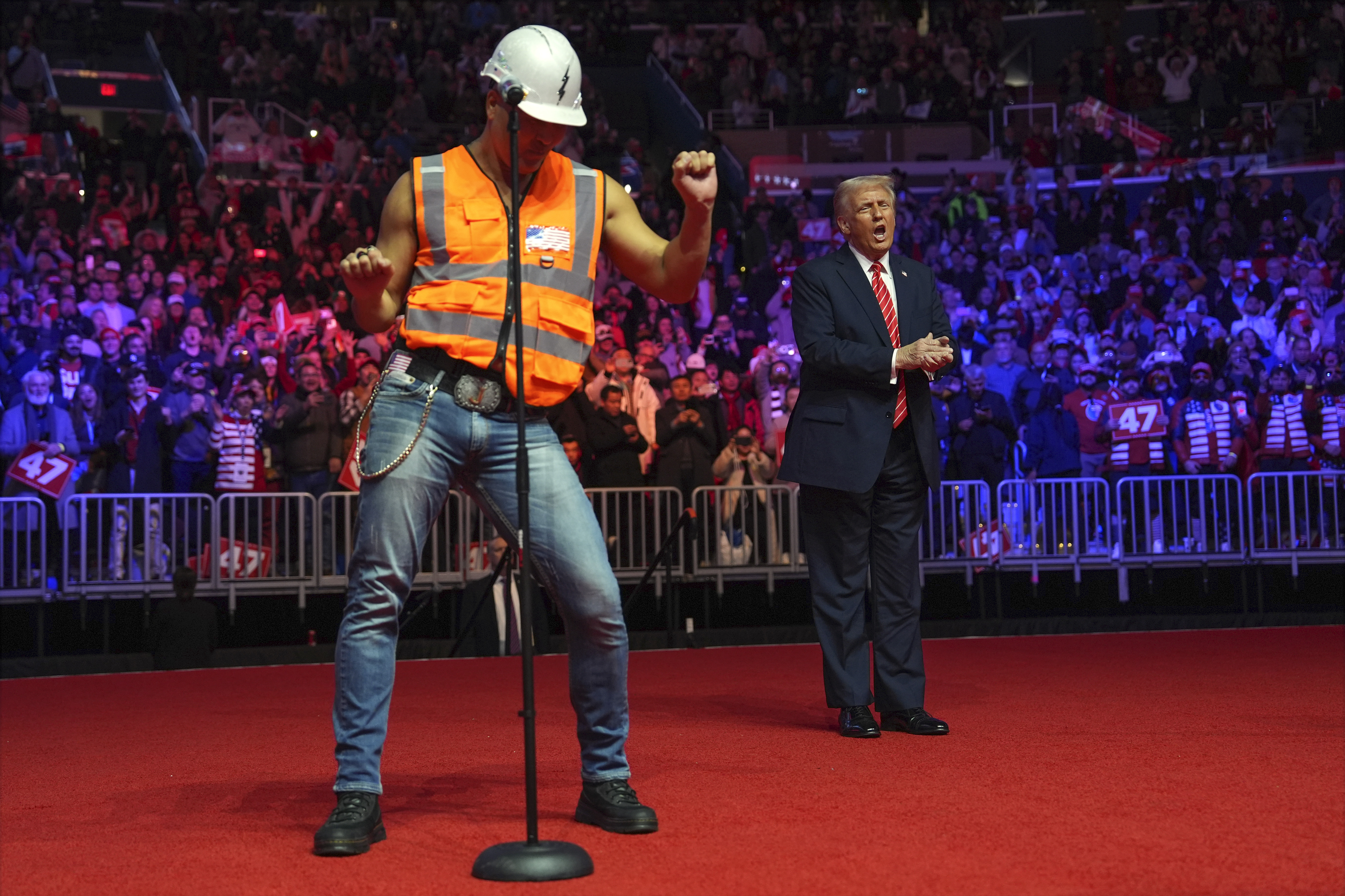 President-elect Donald Trump dances with The Village People at a rally ahead of the 60th Presidential Inauguration, Sunday, Jan. 19, 2025, in Washington. (AP Photo/Evan Vucci)