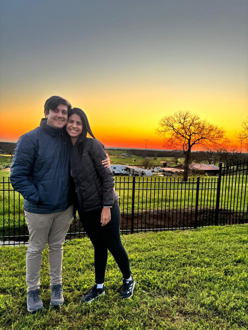 Jesus Armas and Sairam Rivas cuddle against a blazing sunset