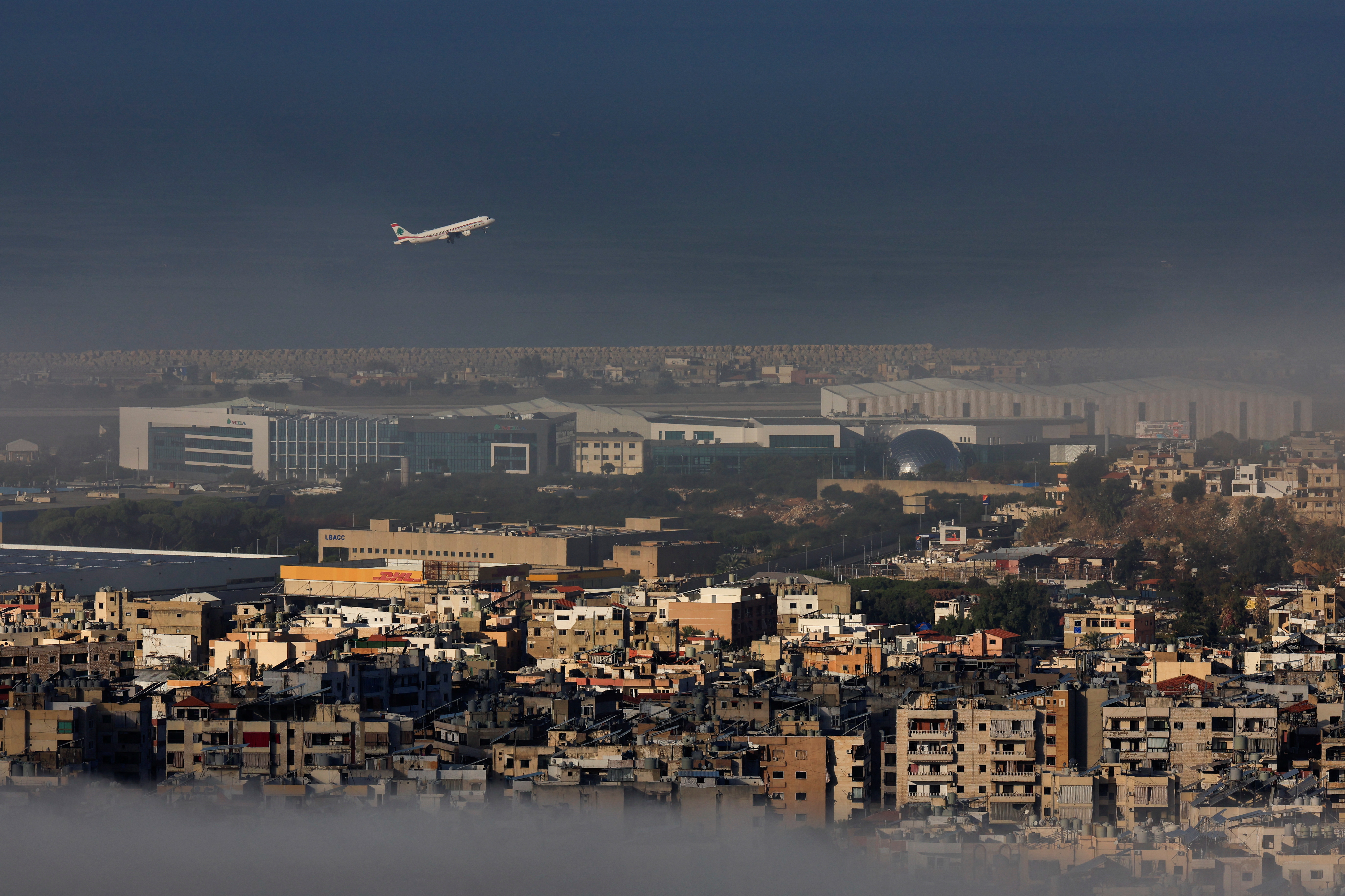 A Lebanese Middle East Airlines (MEA) aircraft flies over Beirut's southern suburbs.