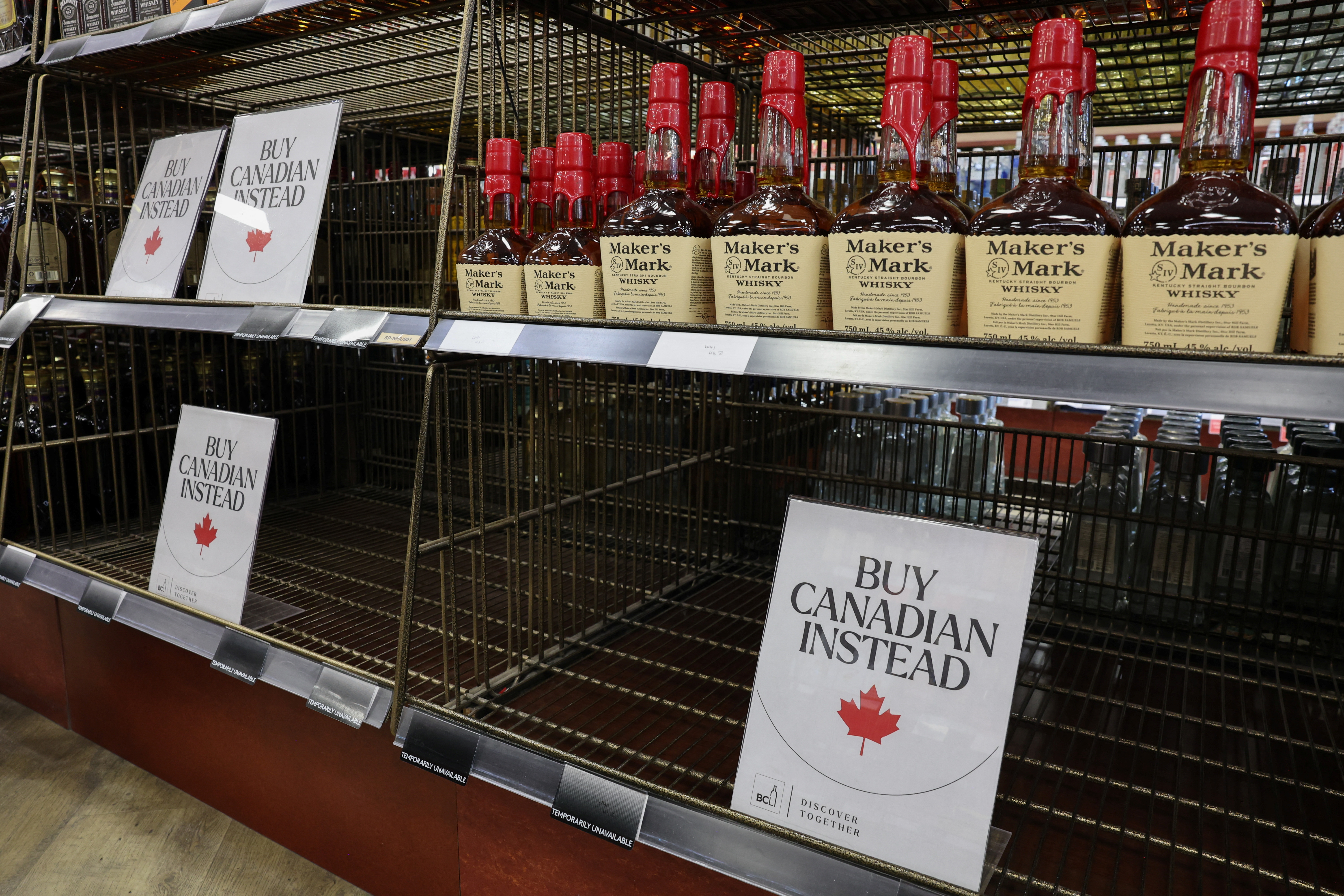 Empty shelves remain with signs ''Buy Canadian Instead'' after the top five U.S. liquor brands were removed from sale at a B.C. Liquor Store, as part of a response to U.S. President Donald Trump's 25% tariffs on Canadian goods, in Vancouver, British Columbia, Canada, February 2, 2025.