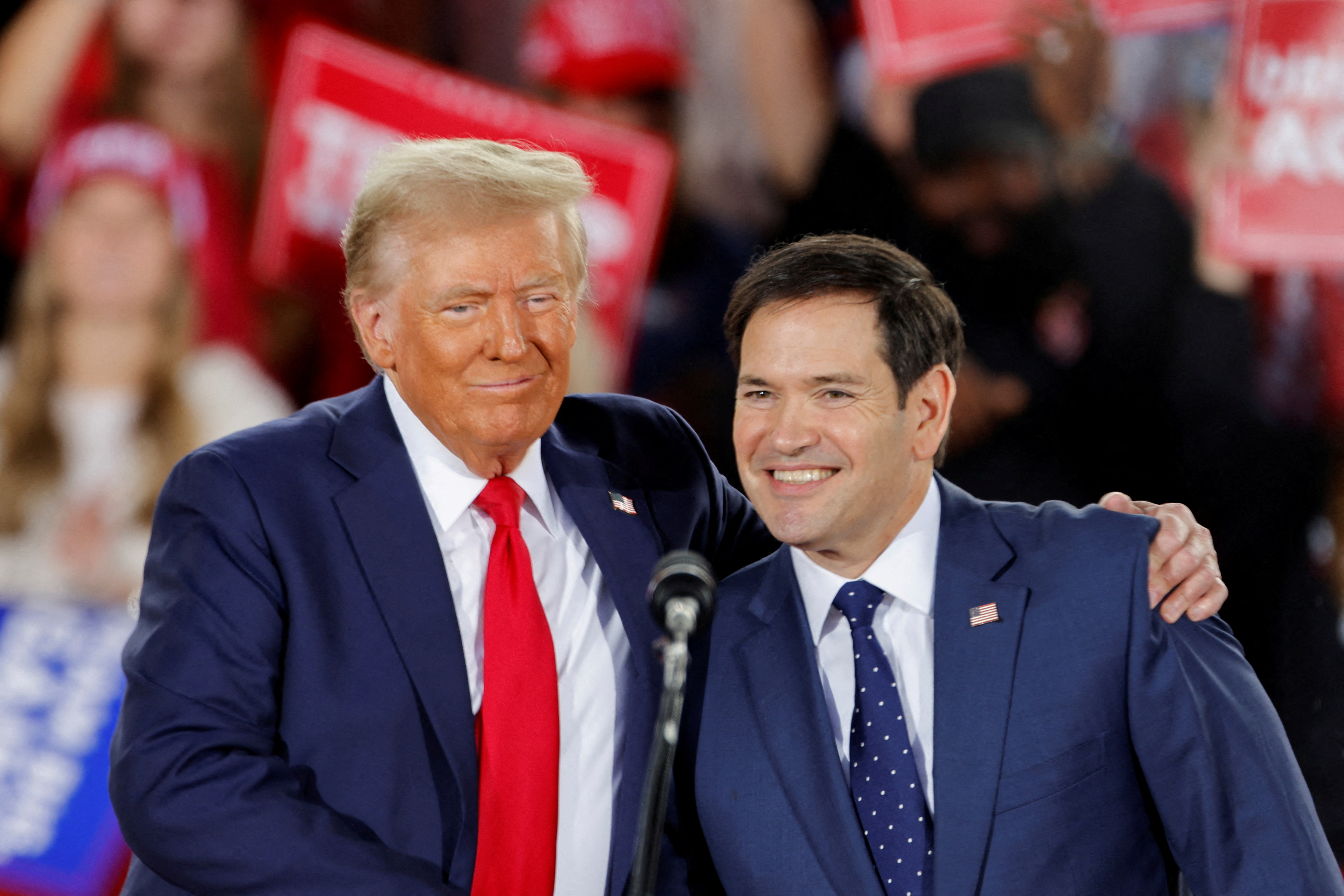 Republican presidential nominee and former U.S. President Donald Trump and and Senator Marco Rubio (R-FL) react during a campaign event at Dorton Arena, in Raleigh, North Carolina, U.S. November 4, 2024.