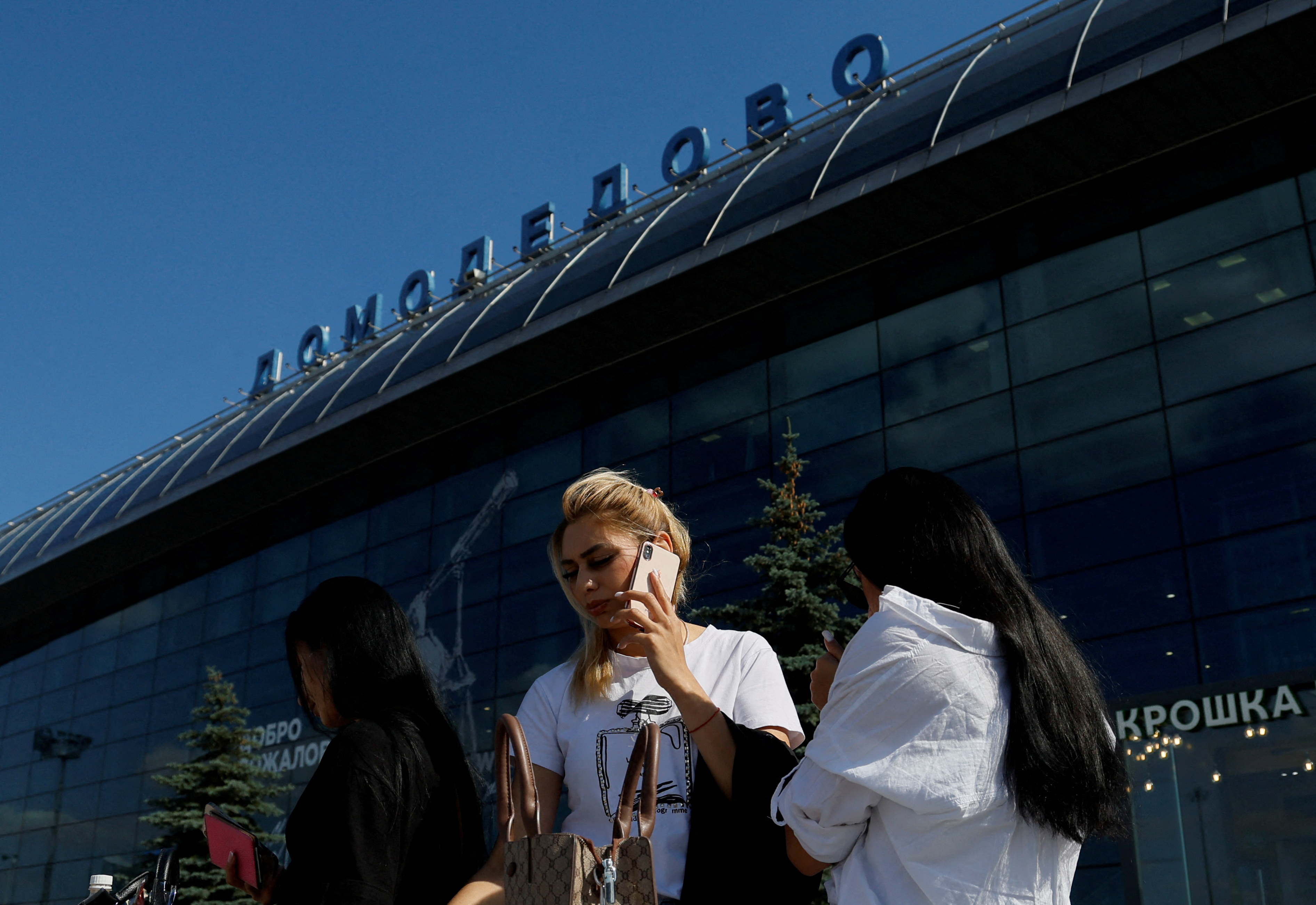 FILE PHOTO: People stand in front of a terminal of the Domodedovo airport outside Moscow, Russia August 21, 2023. REUTERS/Maxim Shemetov/File Photo