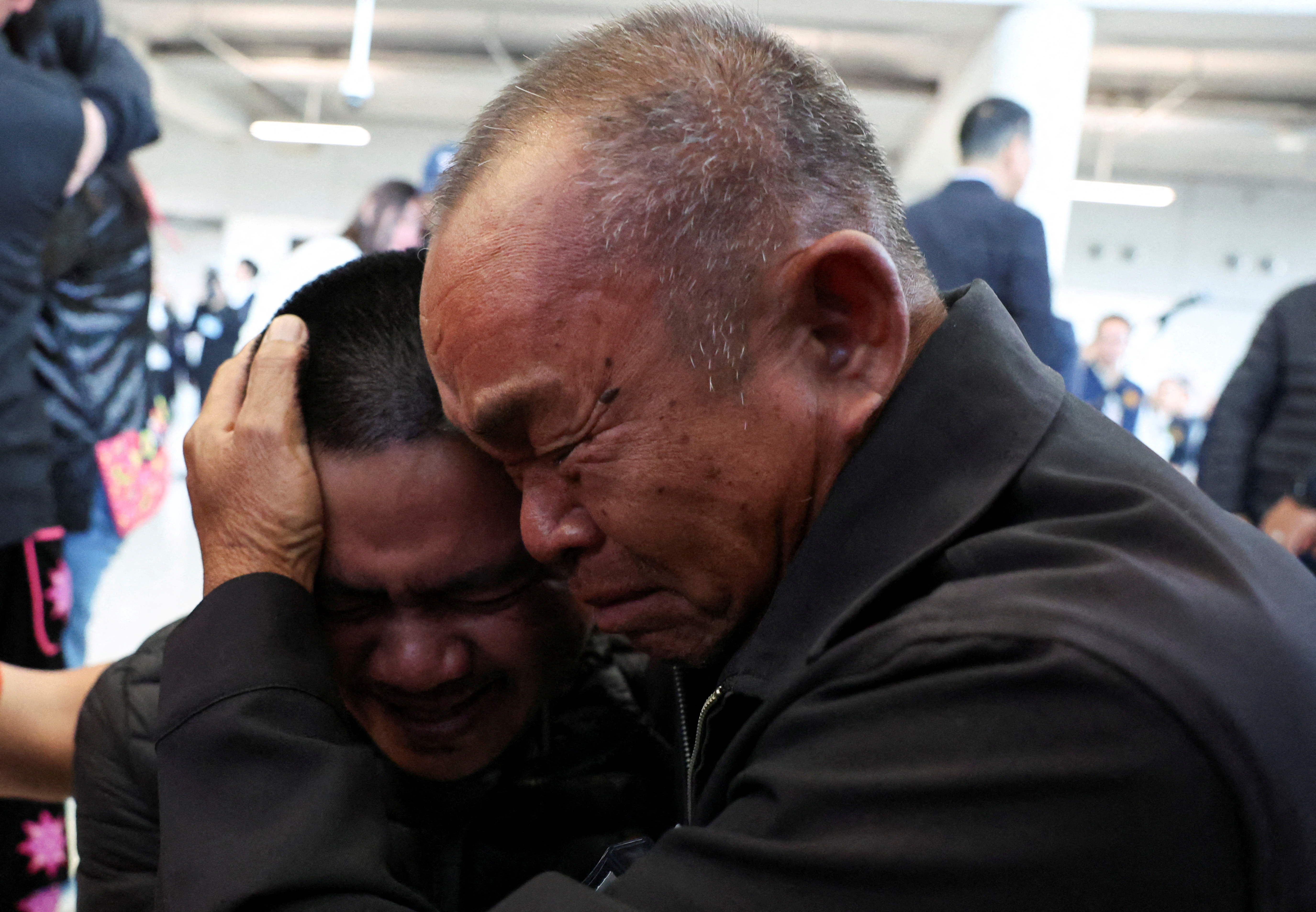 Wilas Thaenna, father of Pongsak Thaenna, one of the released Thai captives, reacts as the five men came out of Suvarnabhumi airport in Thailand