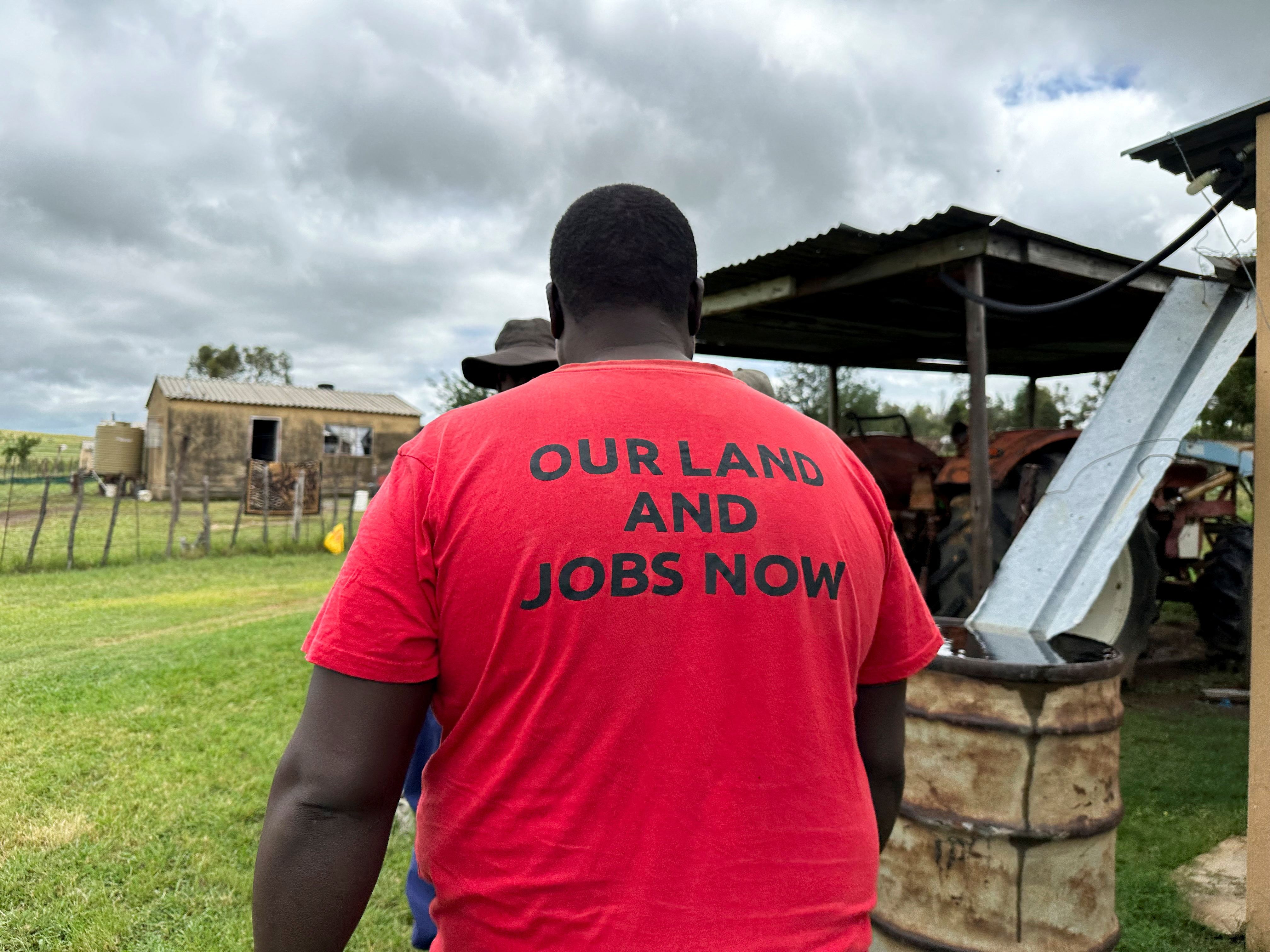 A supporter of the Economic Freedom Fighters (EFF) walks on a farm.