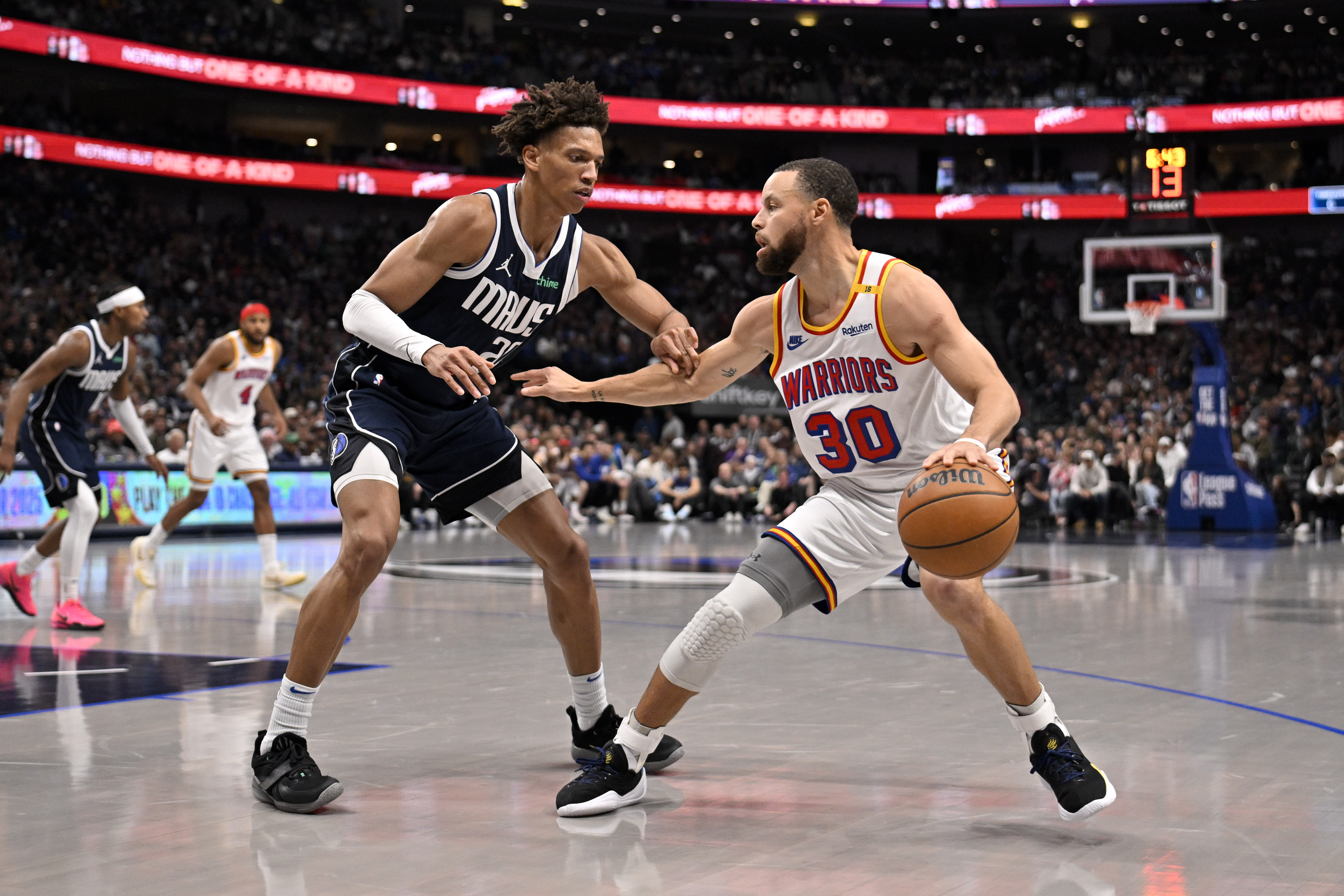 Feb 12, 2025; Dallas, Texas, USA; Golden State Warriors guard Stephen Curry (30) looks to move the ball past Dallas Mavericks forward Kessler Edwards (20) during the second quarter at the American Airlines Center. Mandatory Credit: Jerome Miron-Imagn Images