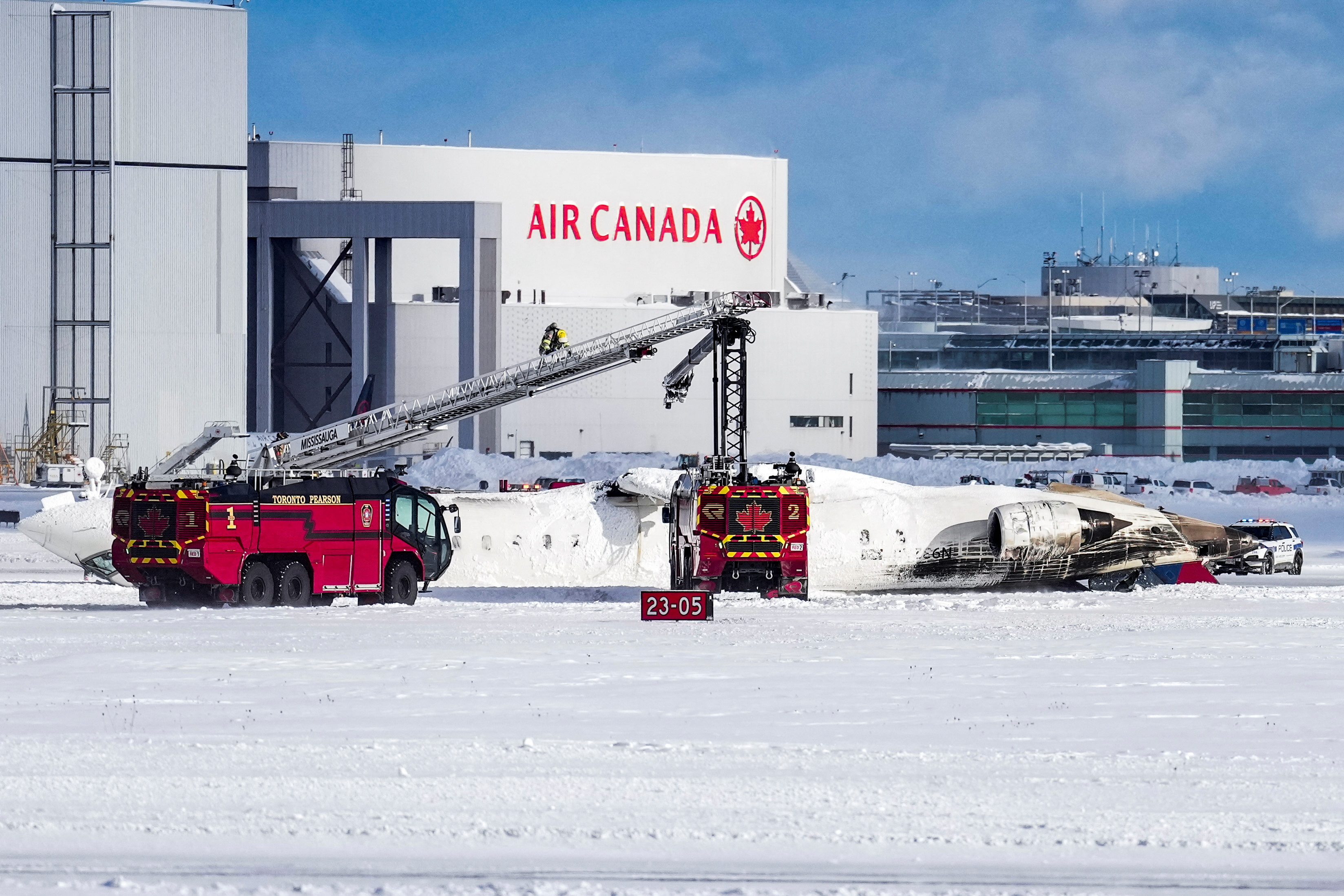 First responders work at the Delta Air Lines plane crash site.