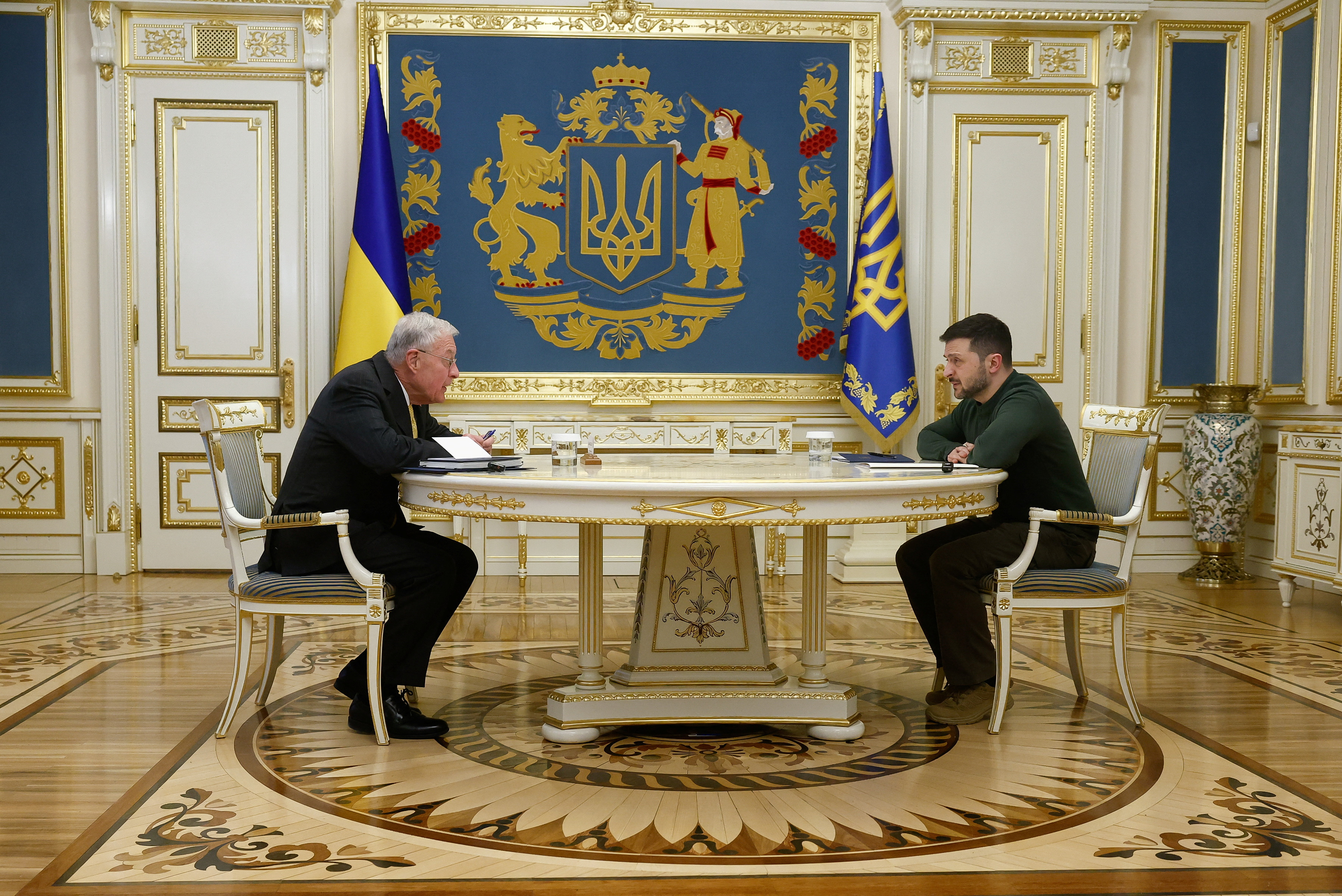 Keith Kellogg and Volodymyr Zelenskyy at a table across from one another